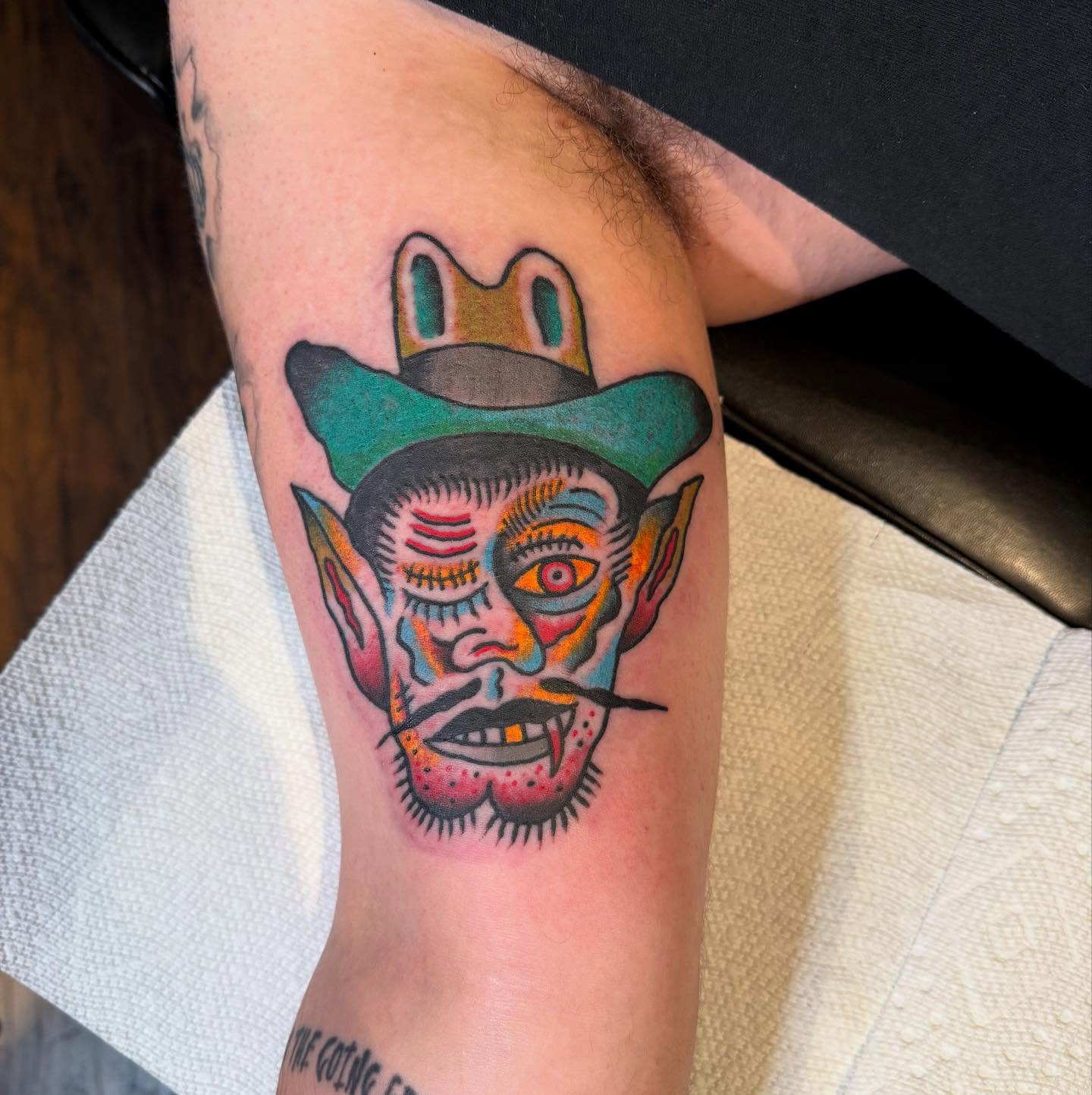 Demon face American traditional tattoo on the forearm by Joe Truck