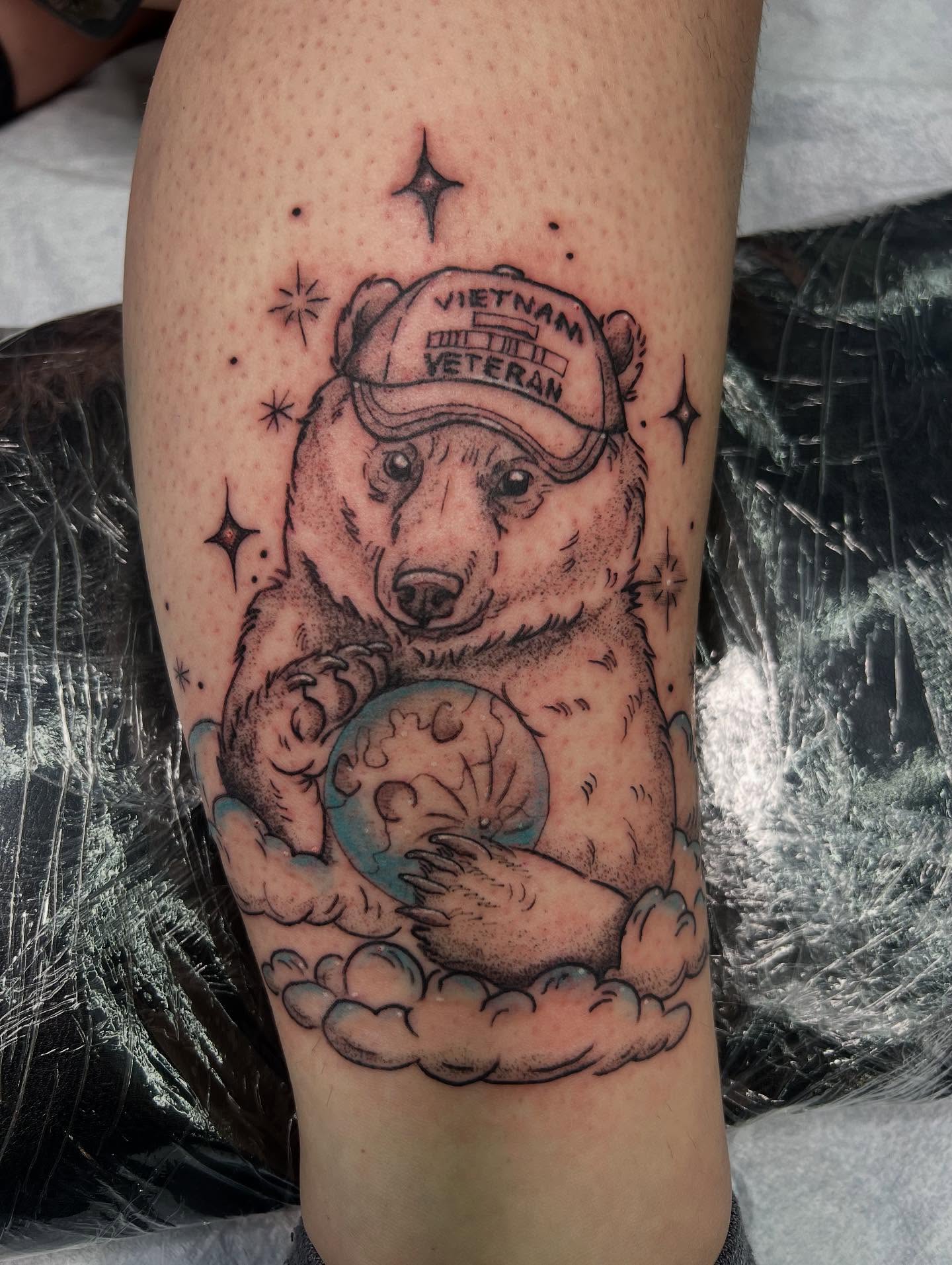 Polar bear with globe black and grey tattoo on the forearm by Monii Arreola