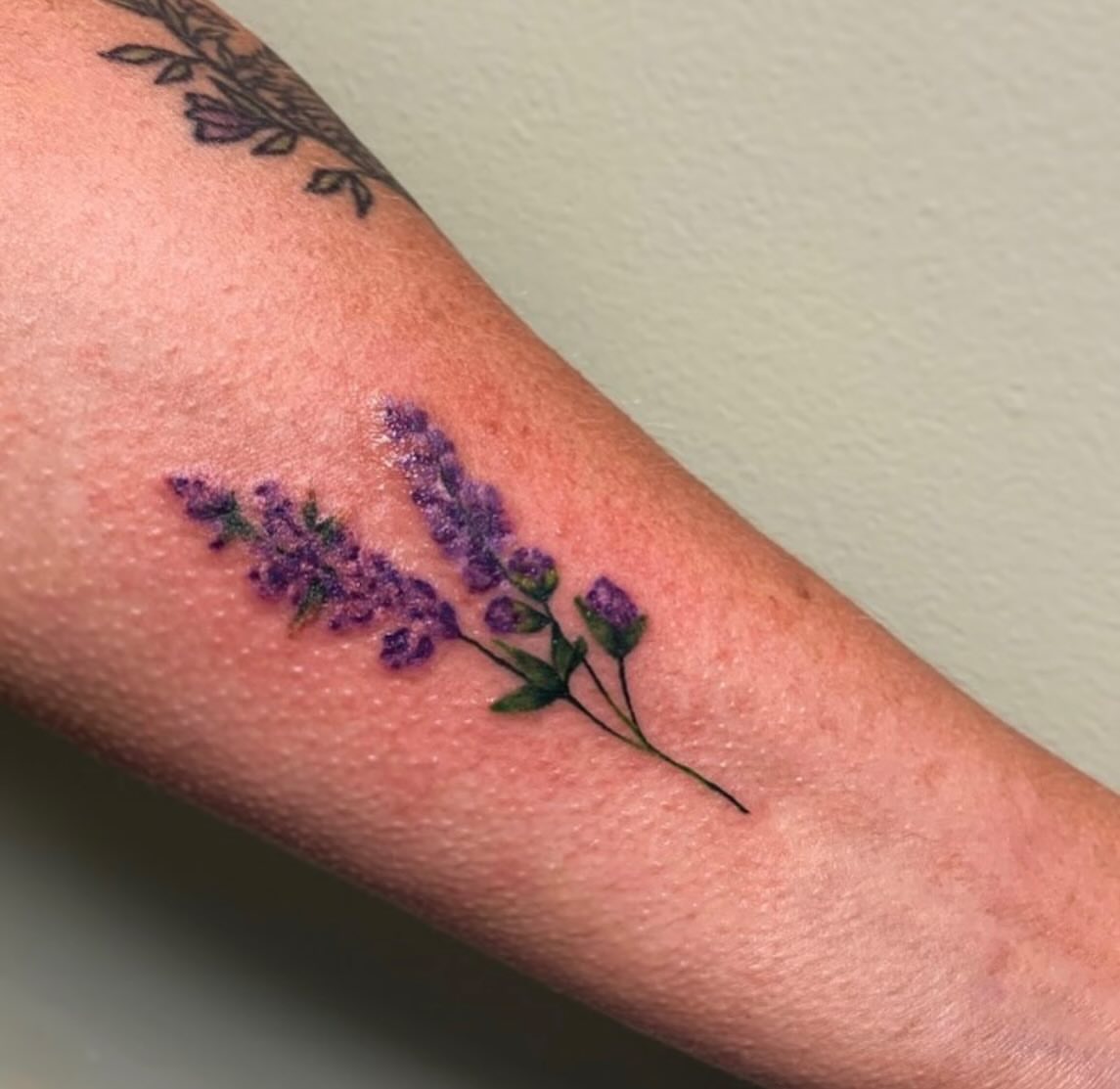 Lavender bouquet dotwork tattoo on the forearm by Lena Lawrence