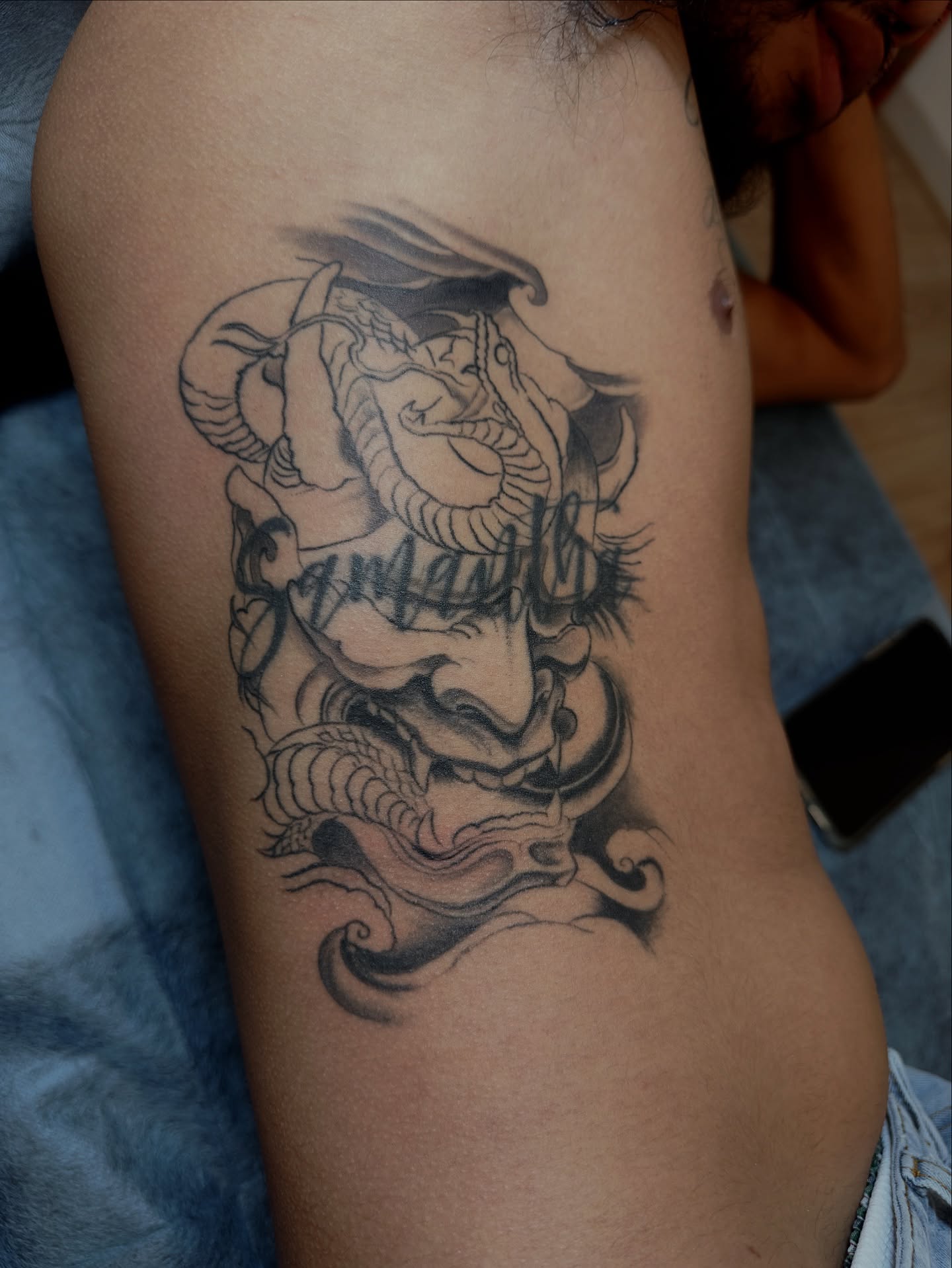 Serpent black and grey tattoo on the thigh by DJ 👨🏾‍🎨