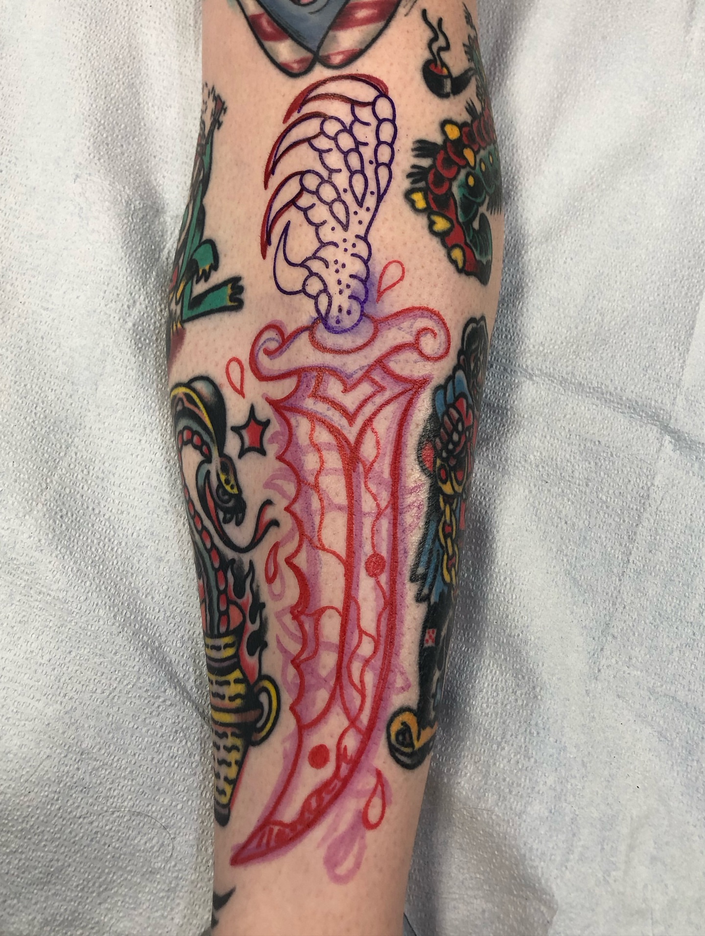 Sword and wings American traditional tattoo on the forearm by Nick Sharratt, Chicago, Illinois