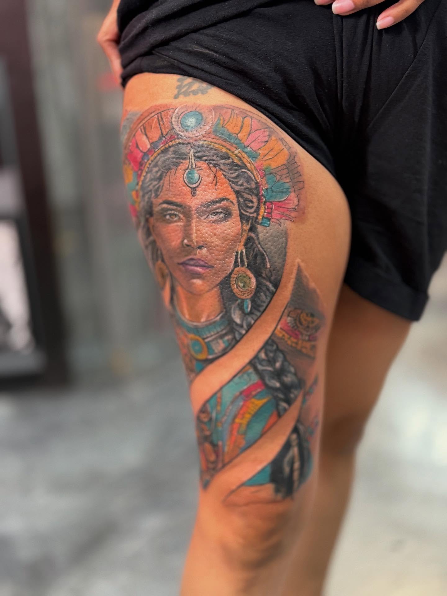 Woman with headdress realism tattoo on the thigh by Alejandro Zaragoza