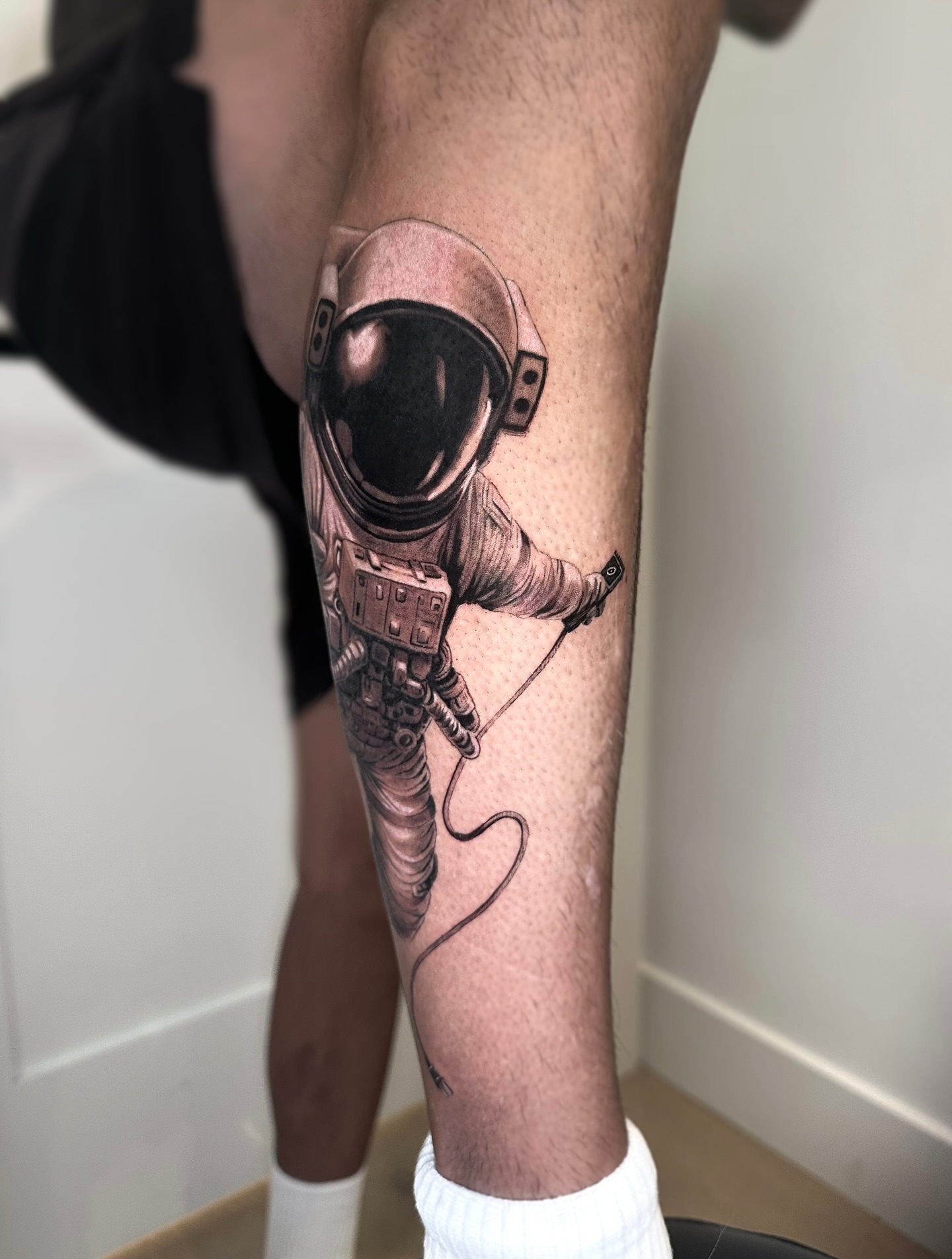 Astronaut realism tattoo on the forearm by Oxana