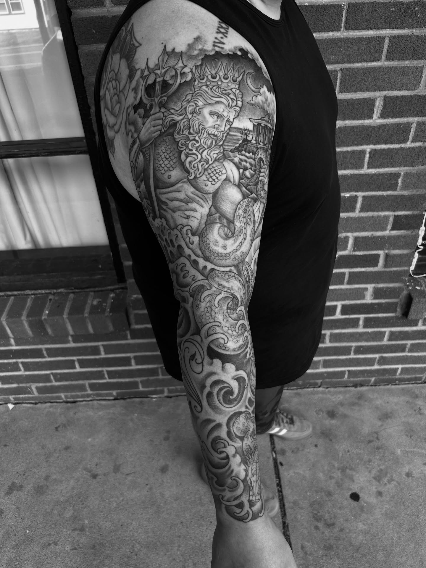 Merman and sea creatures realism tattoo on the upper arm by Patricia Cunningham