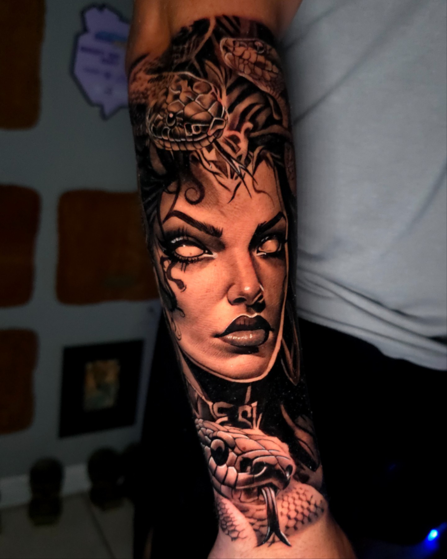 Woman's face with snake realism tattoo on the forearm by Javier M Davila