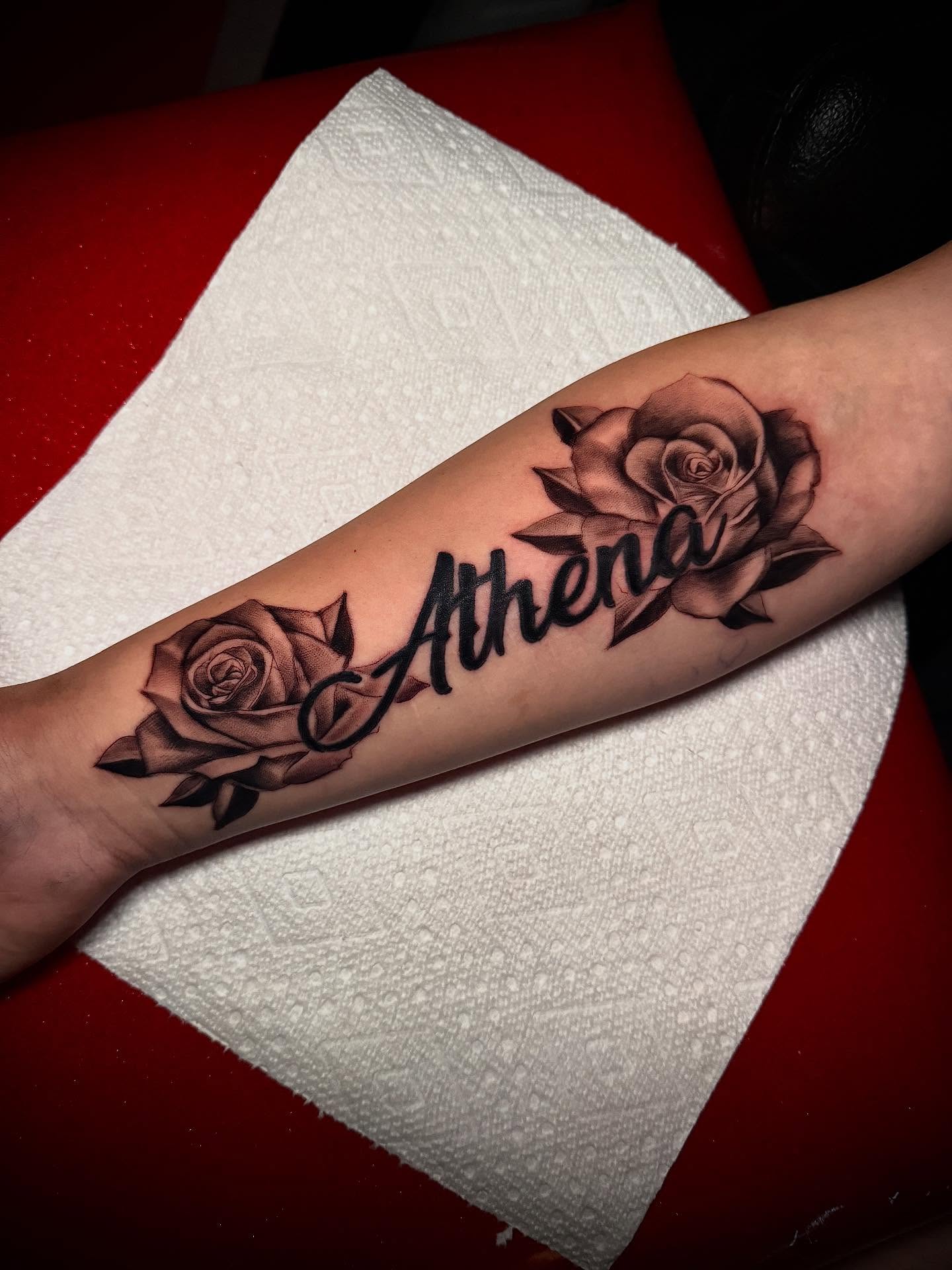 Rose and name black and grey tattoo on the forearm by Lucky Valenzuela, Lakewood, Colorado