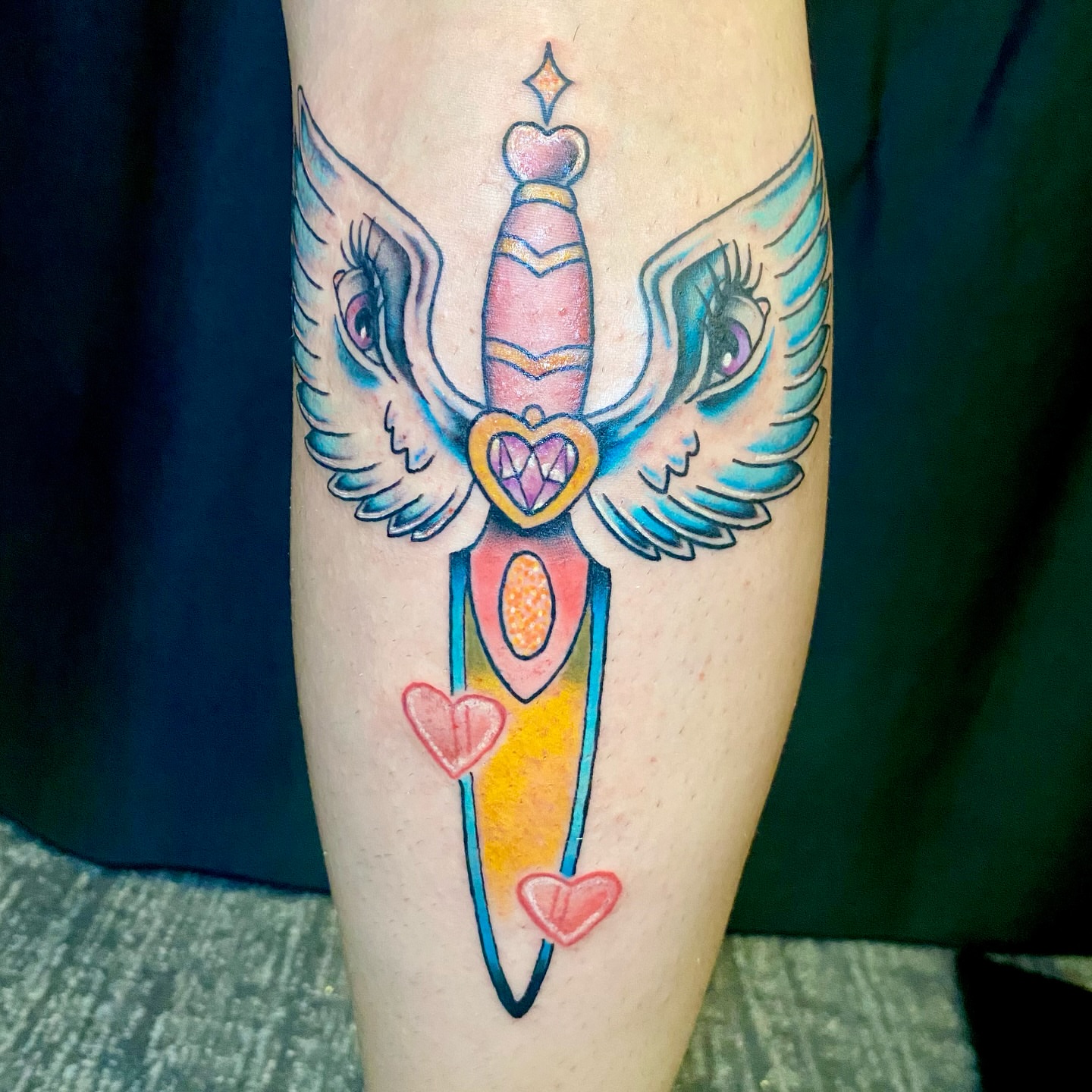 Winged sword new school tattoo on the forearm by Ashley Lin Las Vegas Tattoo Artist