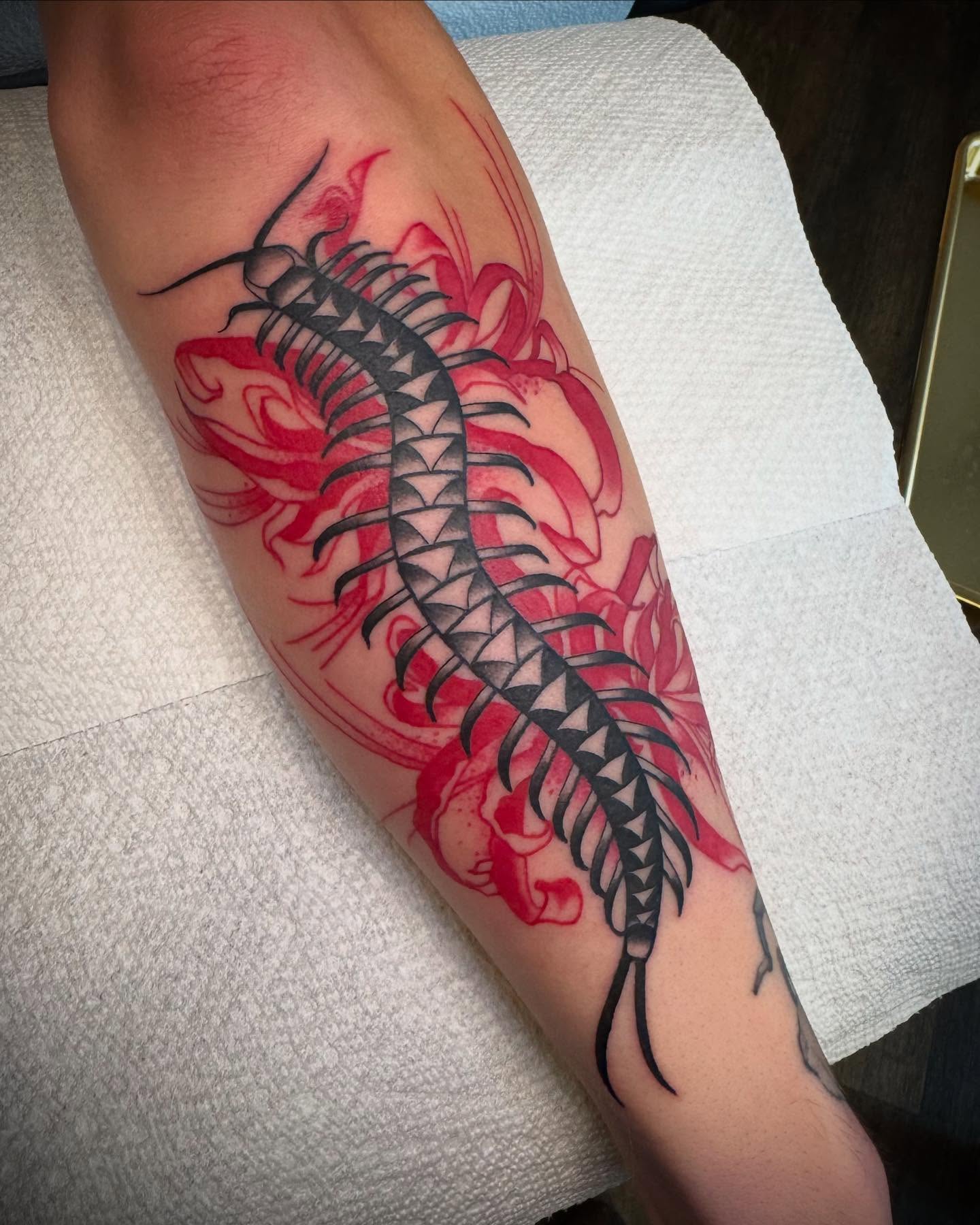 Centipede geometric tattoo on the forearm by Paul Giovis