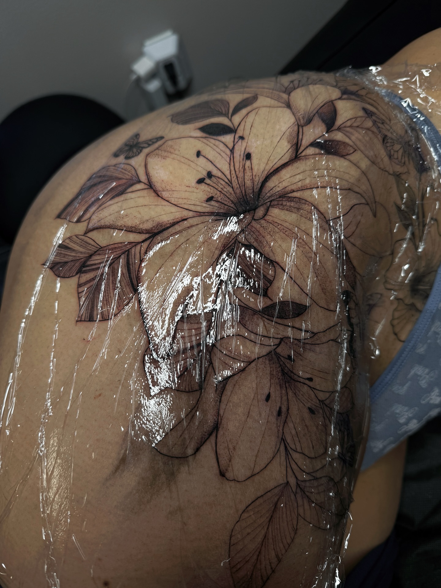 Lily black and grey tattoo on the shoulder by ᴍᴀɢɢɪᴇ ✧, Las Vegas, Nevada