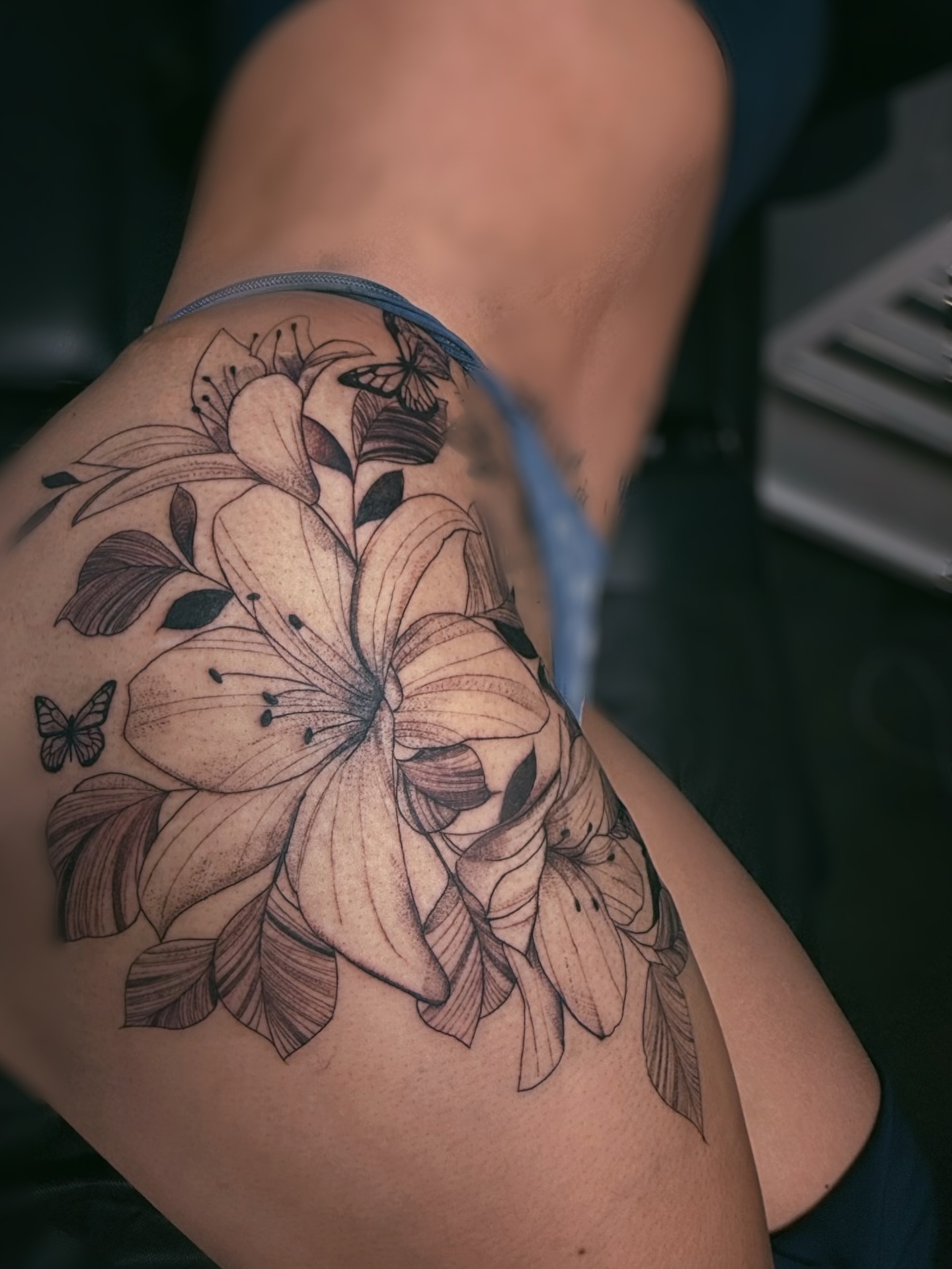 Lilies and butterflies realism tattoo on the thigh by ᴍᴀɢɢɪᴇ ✧, Las Vegas, Nevada