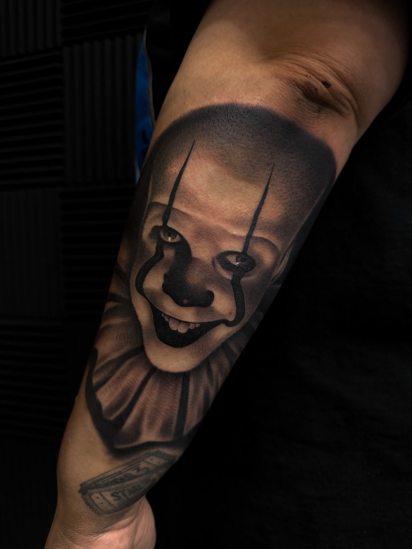 Clown face realism tattoo on the forearm by Nick Campbell
