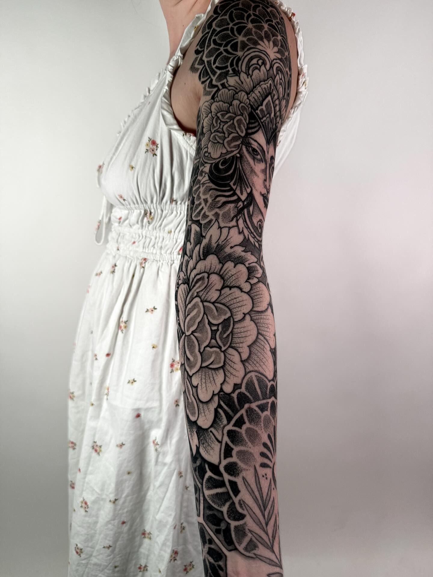 Floral black and grey tattoo on the upper arm by Jamie Beach, Wheat Ridge, Colorado