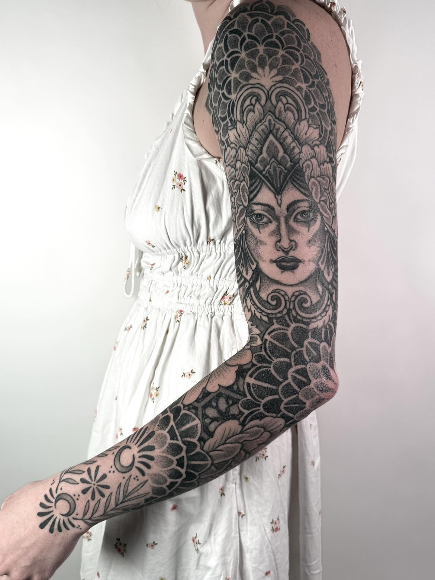 Woman's face with floral patterns realism tattoo on the upper arm by Jamie Beach, Wheat Ridge, Colorado