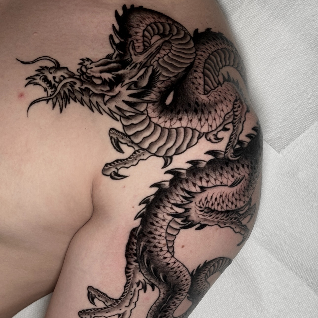Dragon black and grey tattoo on the shoulder by Matt Elliott, Murfreesboro, Tennessee