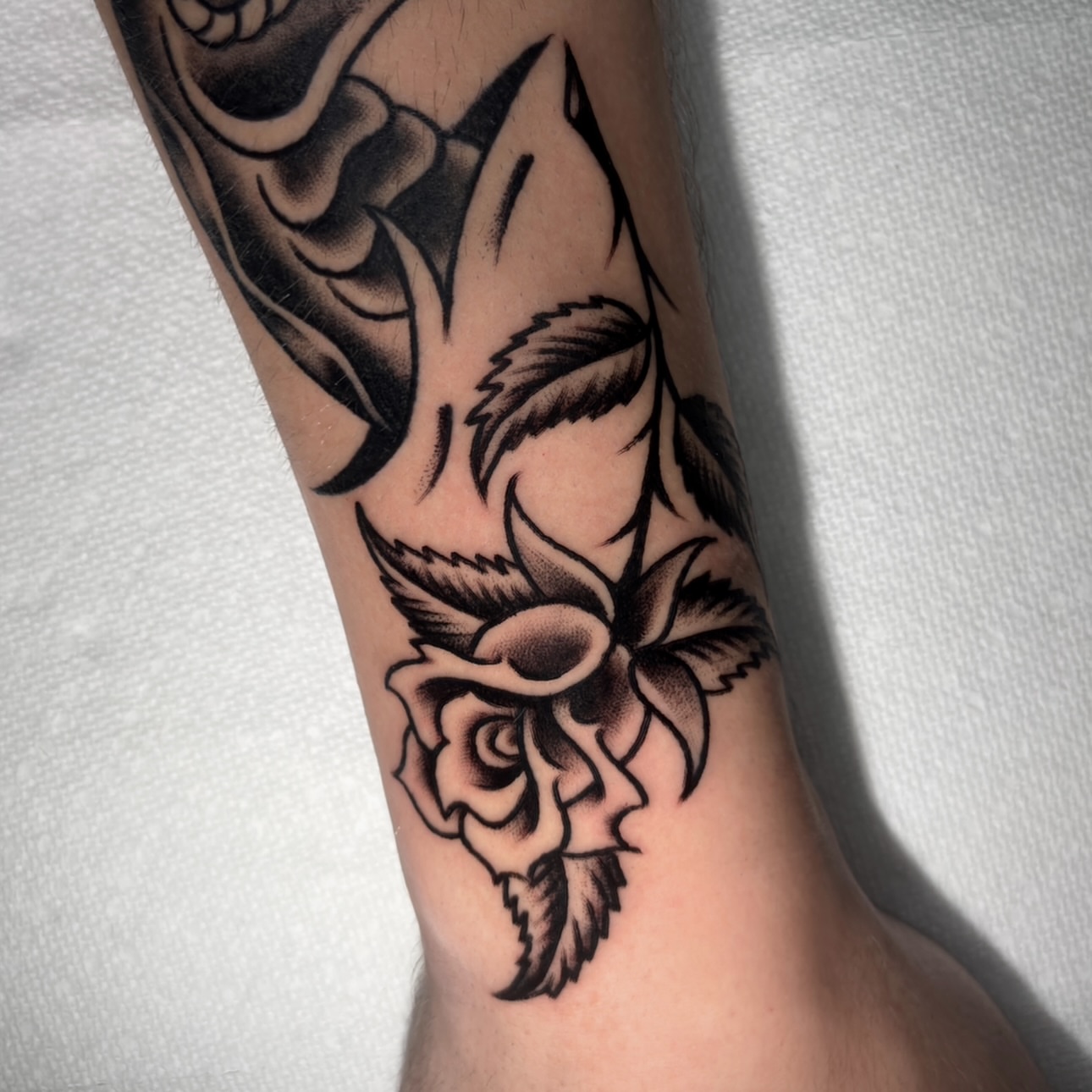 Rose and skull black and grey tattoo on the forearm by Matt Elliott, Murfreesboro, Tennessee