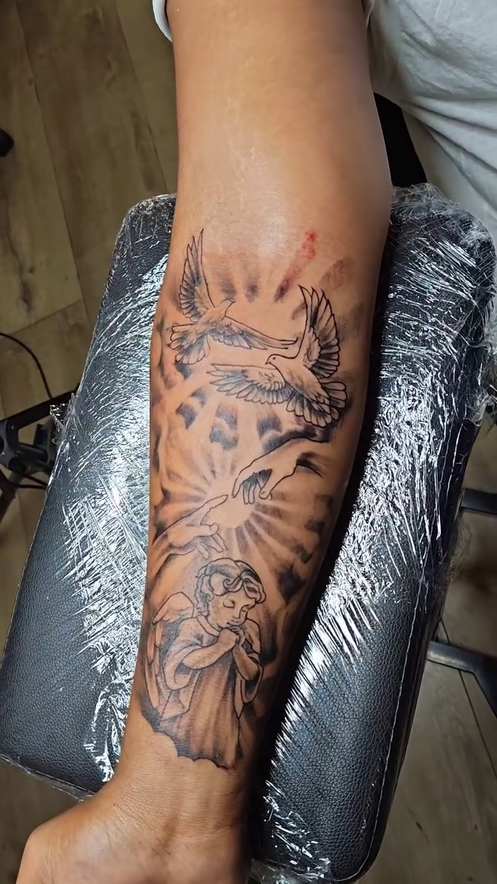 Angel with doves and sun rays realism tattoo on the forearm by @cvpital