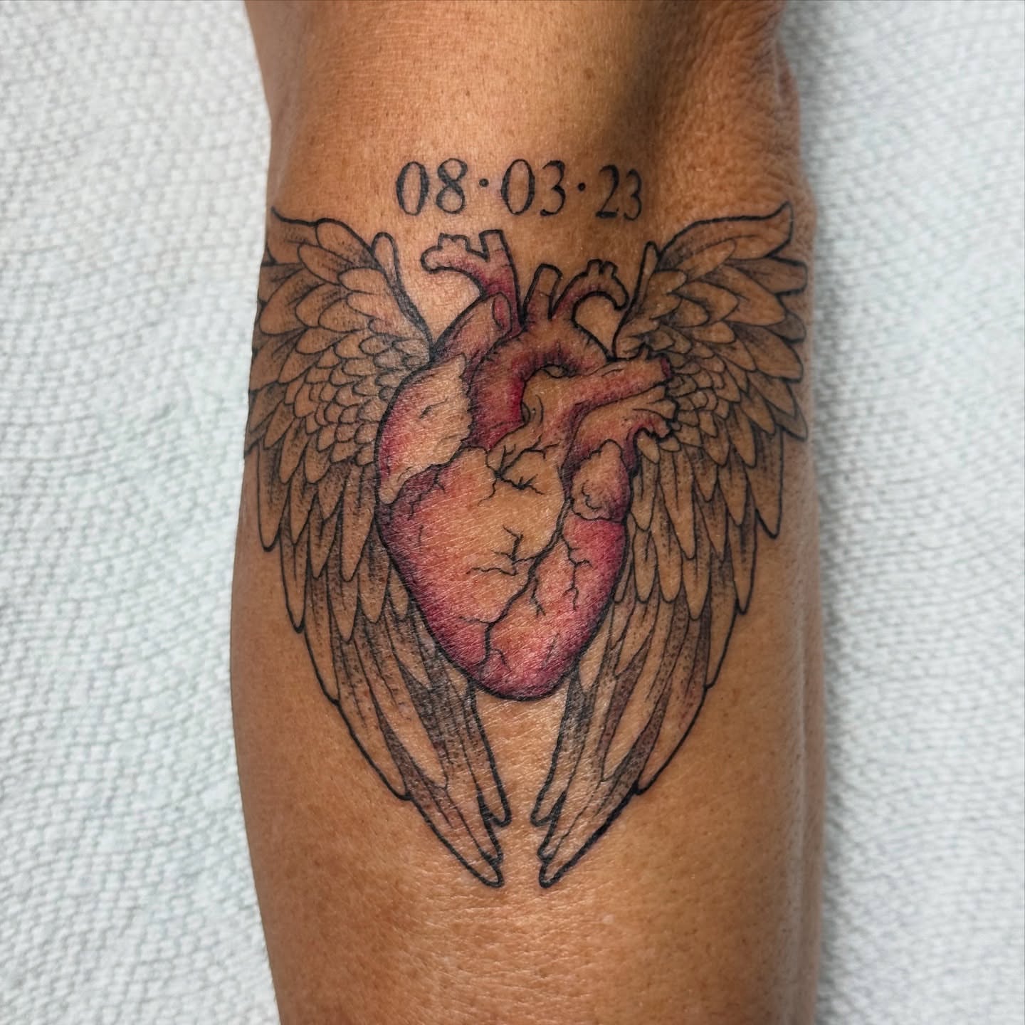 Heart with wings realism tattoo on the forearm by Lacee-Beth Finch