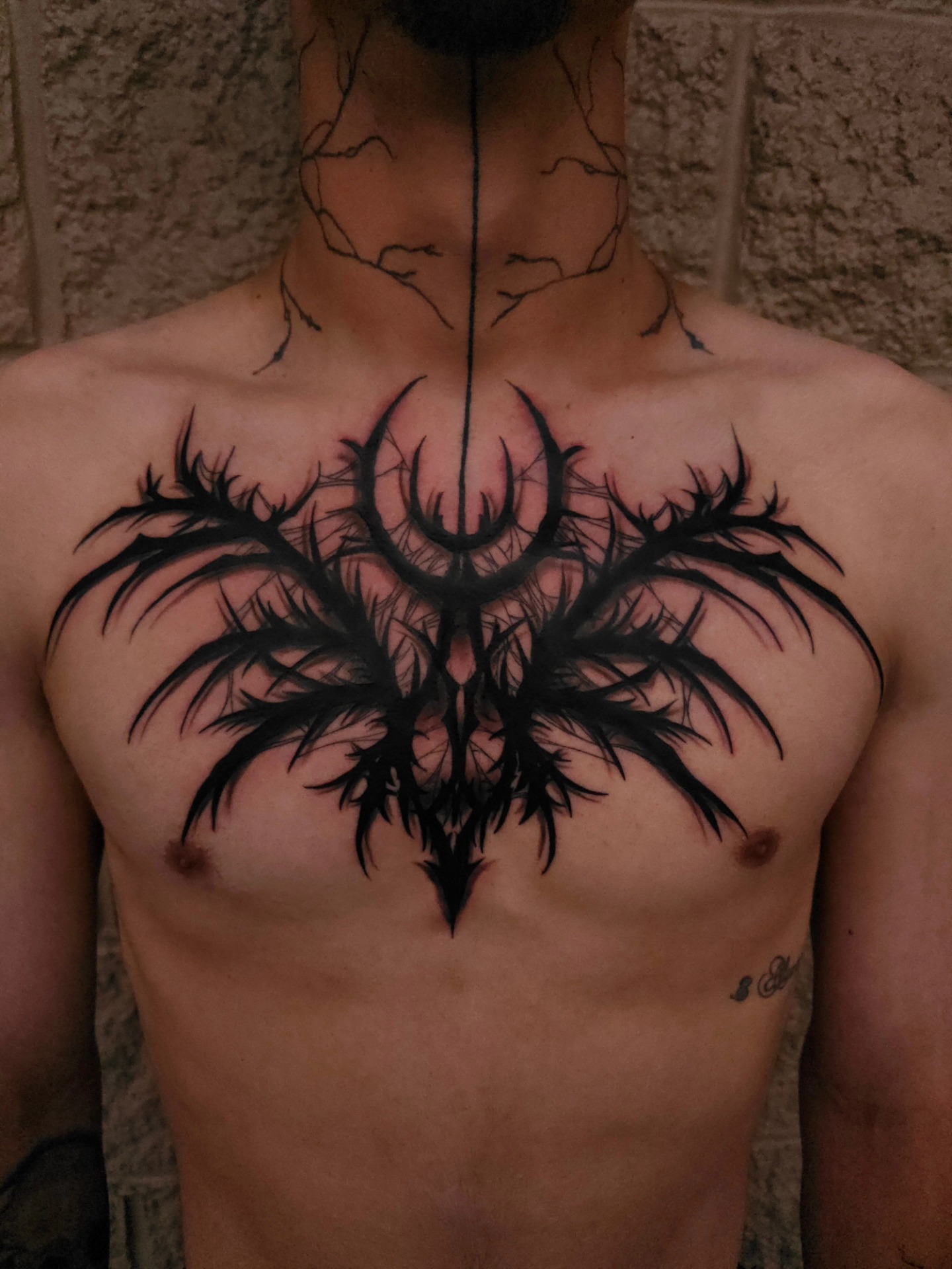 Spider tribal tattoo on the chest by Devan Vankirk