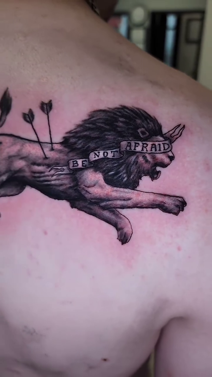 Lion with arrows and blindfold realism tattoo by Zach Mullins