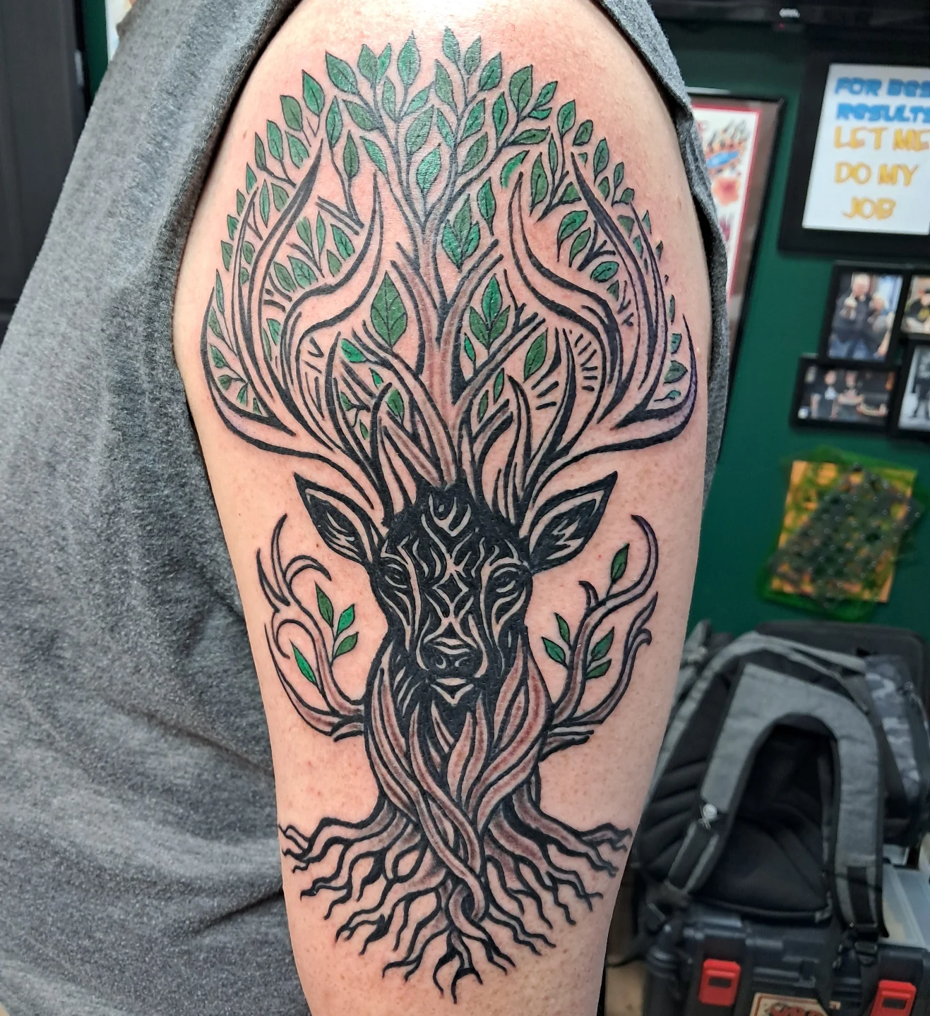 Deer head with tree black and grey tattoo on the forearm by Reb Fularz