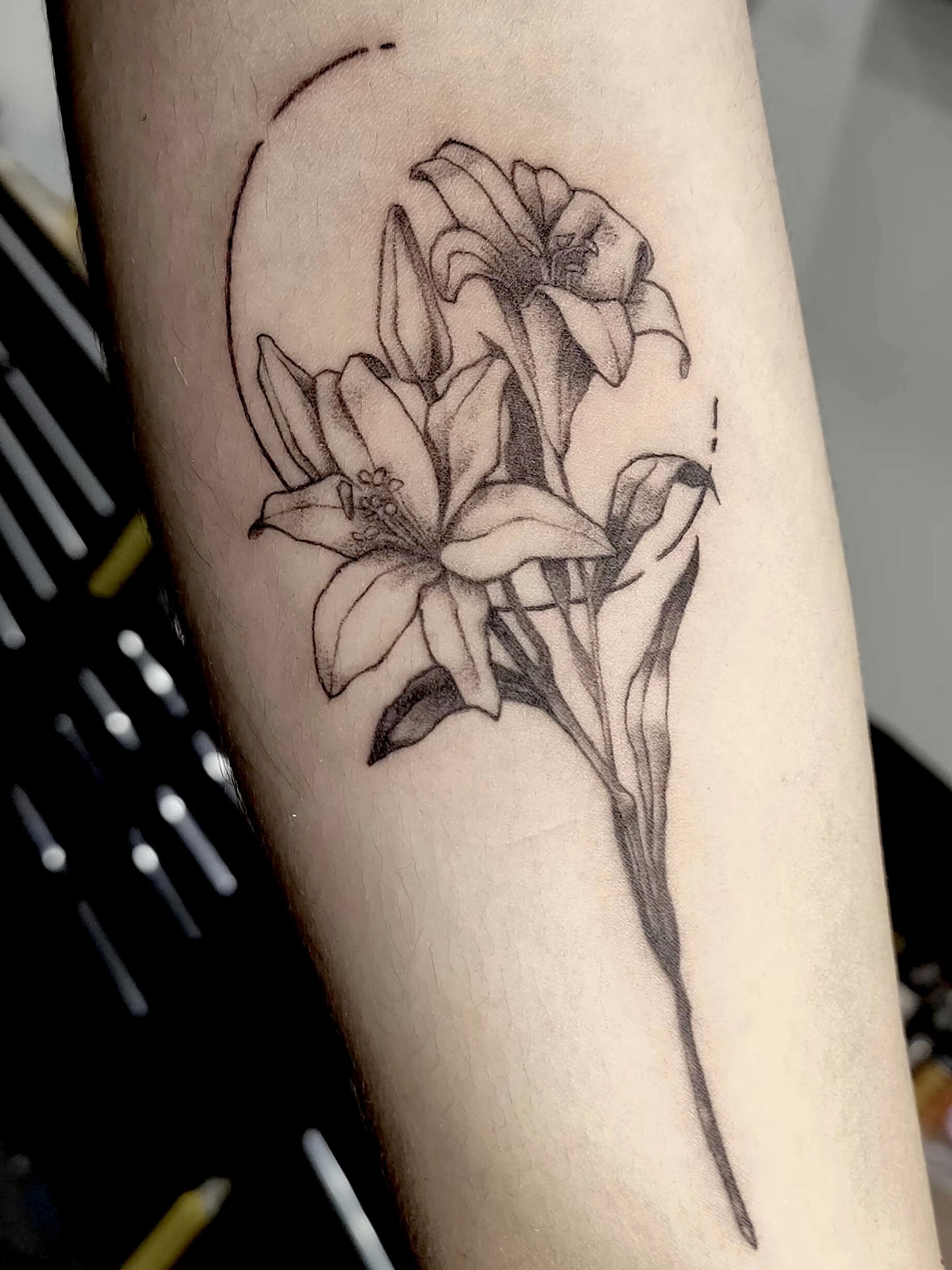 Lilies black and grey tattoo on the forearm by Sydney Walk in Tattoo, Sydney, New South Wales