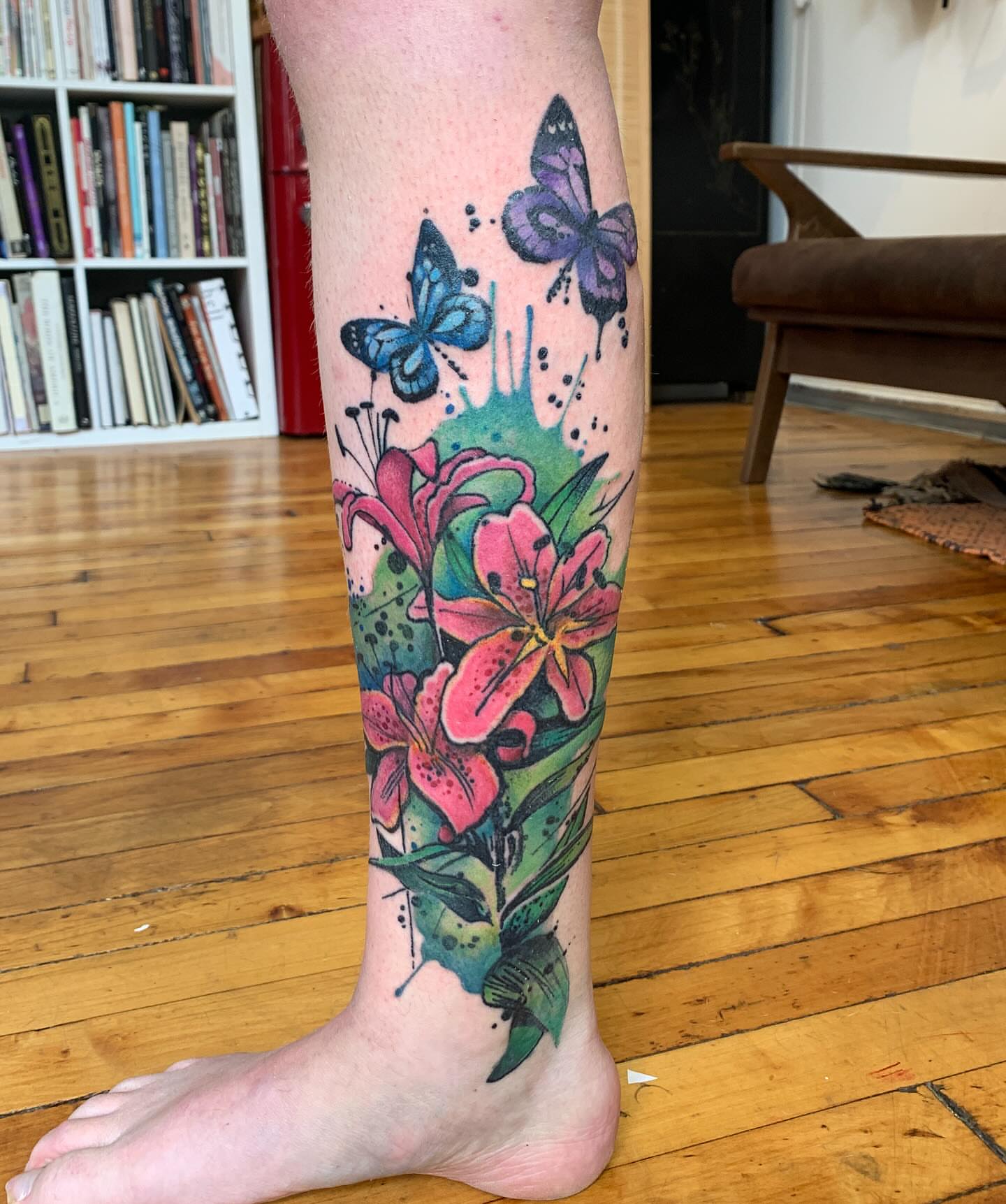 Lilies and butterflies watercolor tattoo on the calf by Gene Coffey, New York, New York