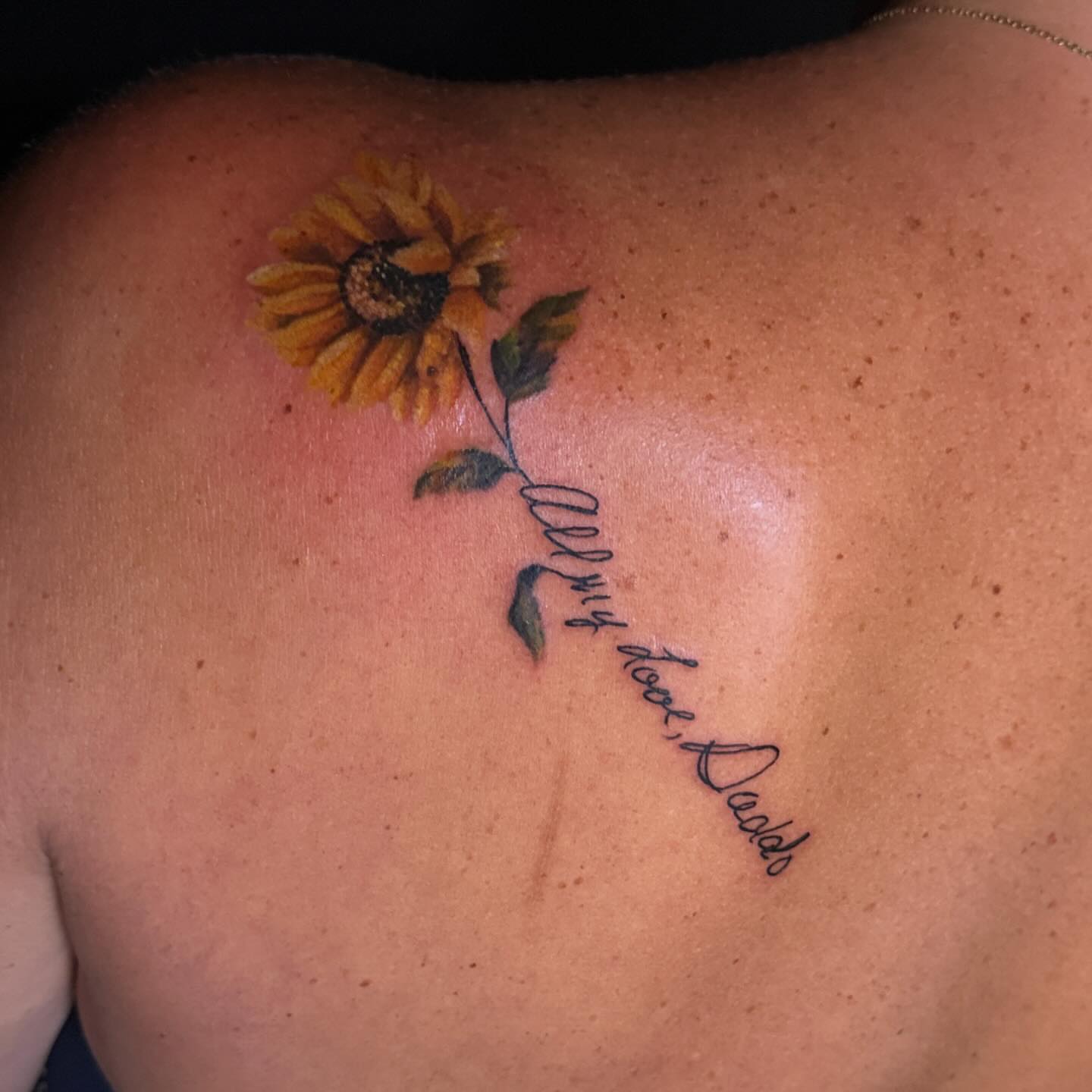 Sunflower realism tattoo on the back by Troy Butner