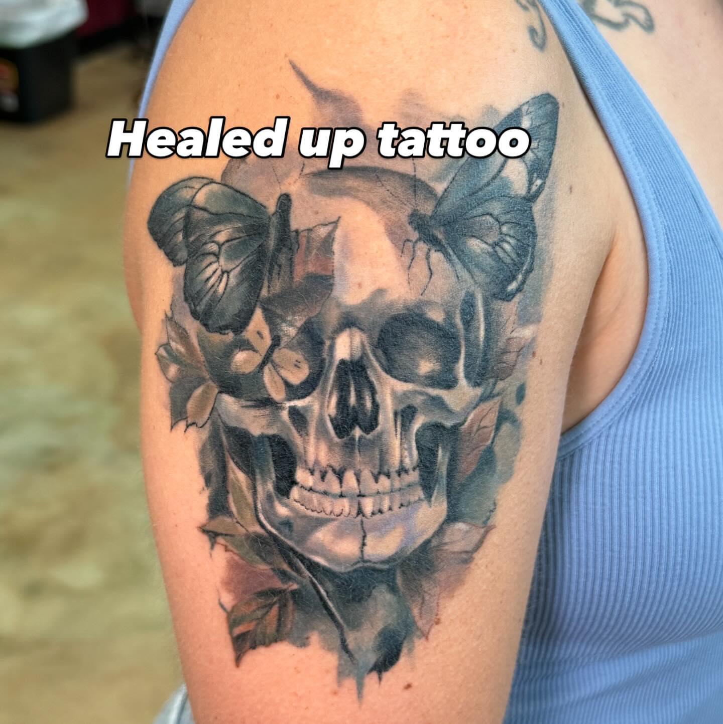 Skull and butterflies realism tattoo on the shoulder by Shawn Cook