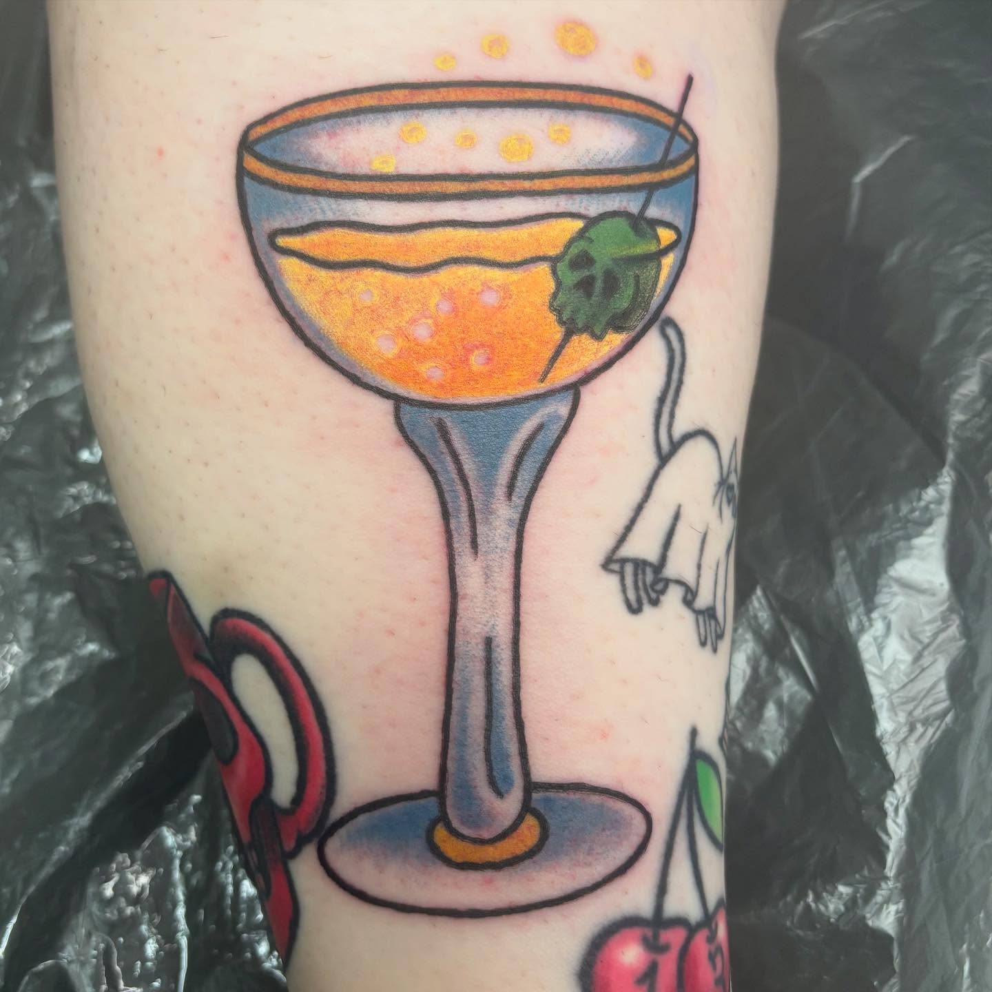 Martini glass American traditional tattoo on the forearm by Oscar Cuéllar (Kue-Yar)