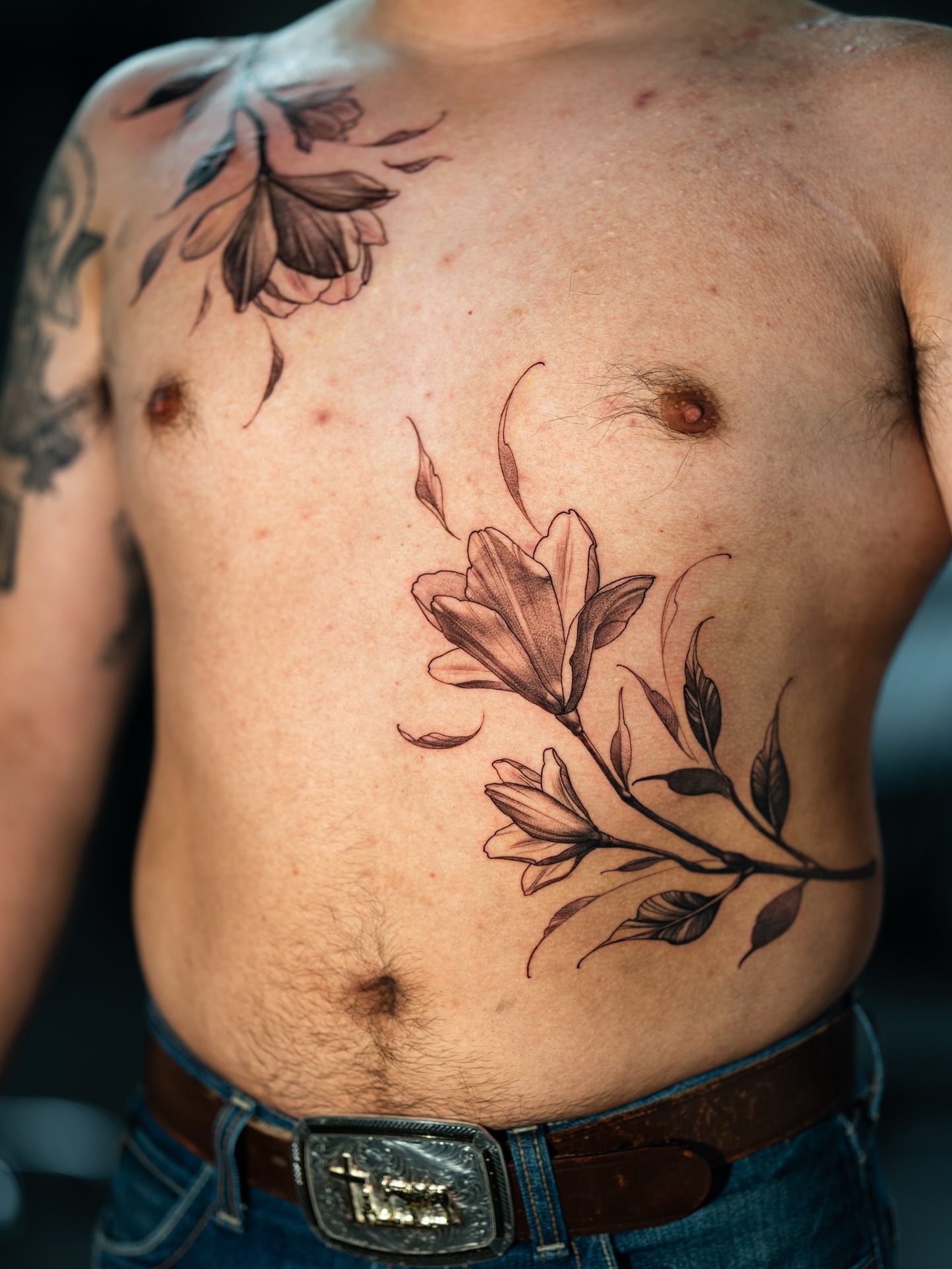 Flower branch black and grey tattoo on the chest by Joey Hella Tattoo Artist