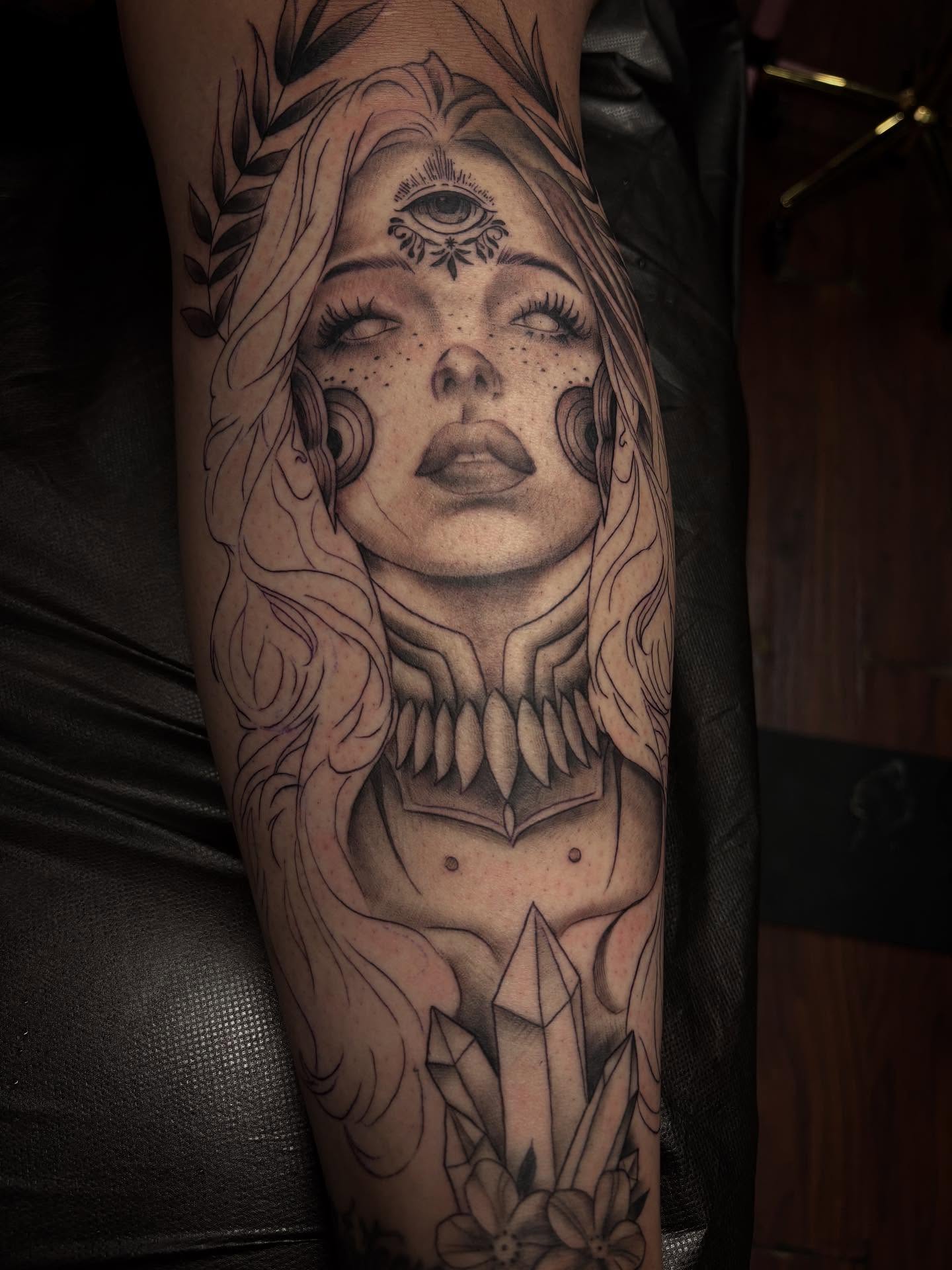 Woman with crystal realism tattoo on the forearm by Alexandria