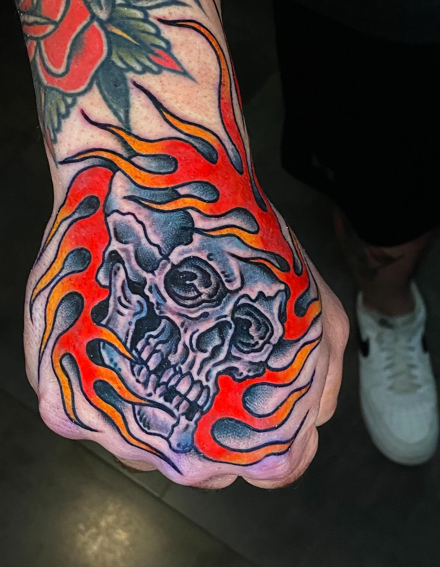 Flaming skull neo-traditional tattoo on the foot by Alex Muniz