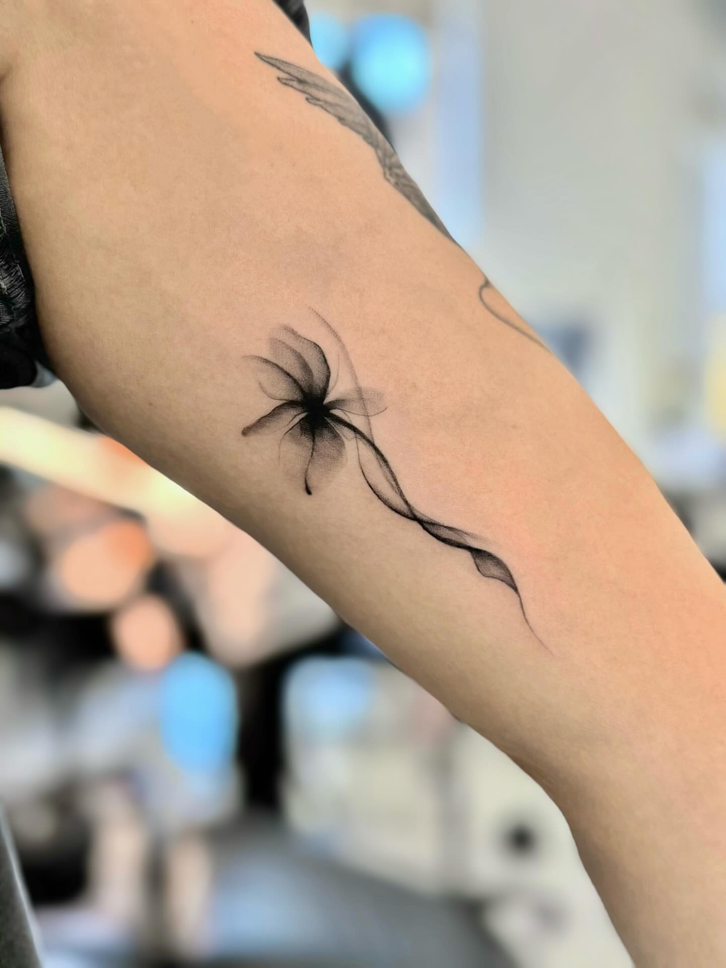 Abstract flower black and grey tattoo on the forearm by David H.