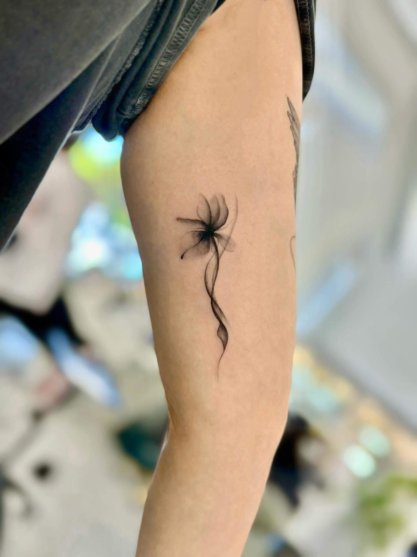 Dandelion black and grey tattoo on the forearm by David H.