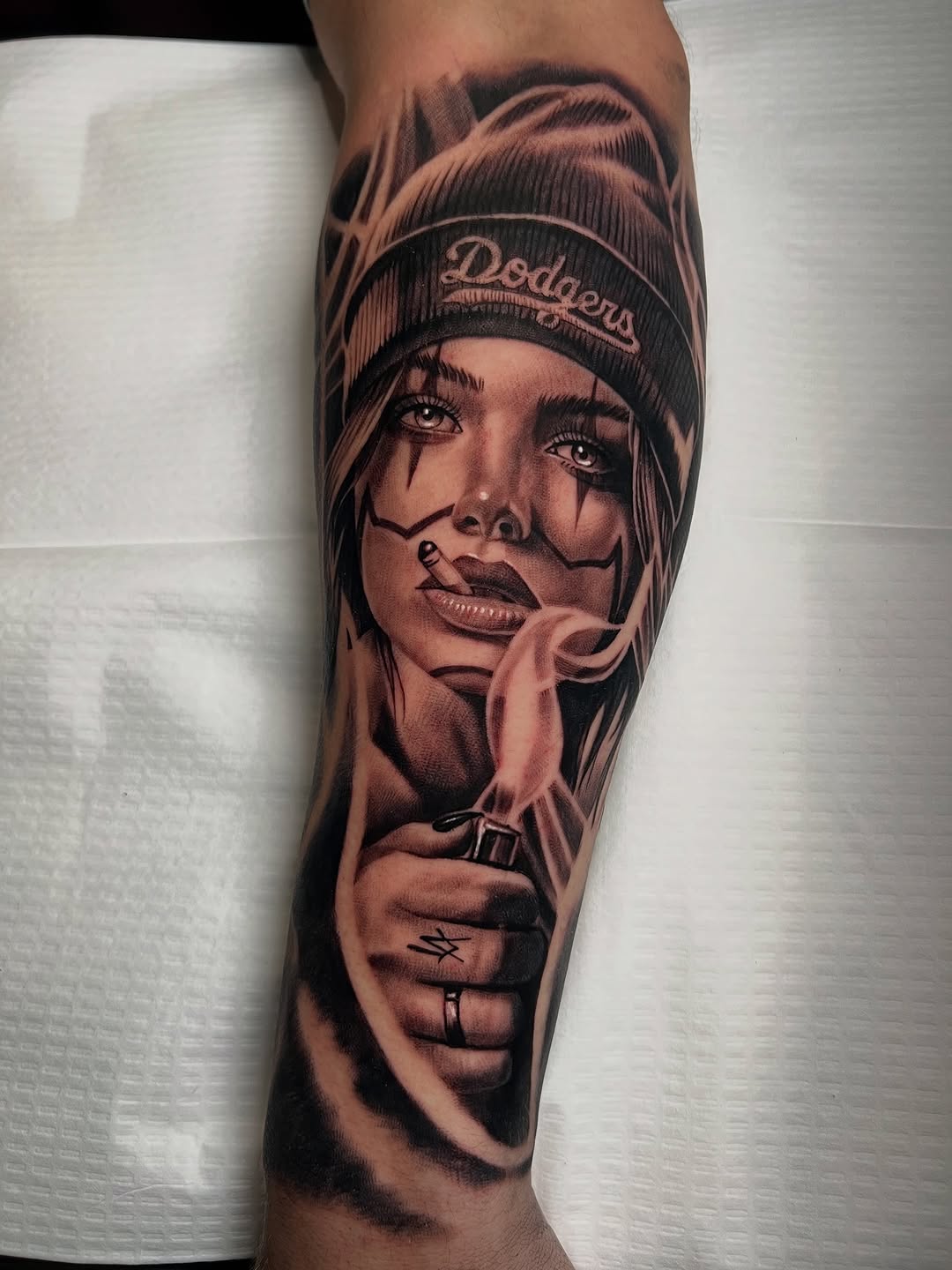 Woman with beanie and lighter Chicano tattoo on the forearm by BJ