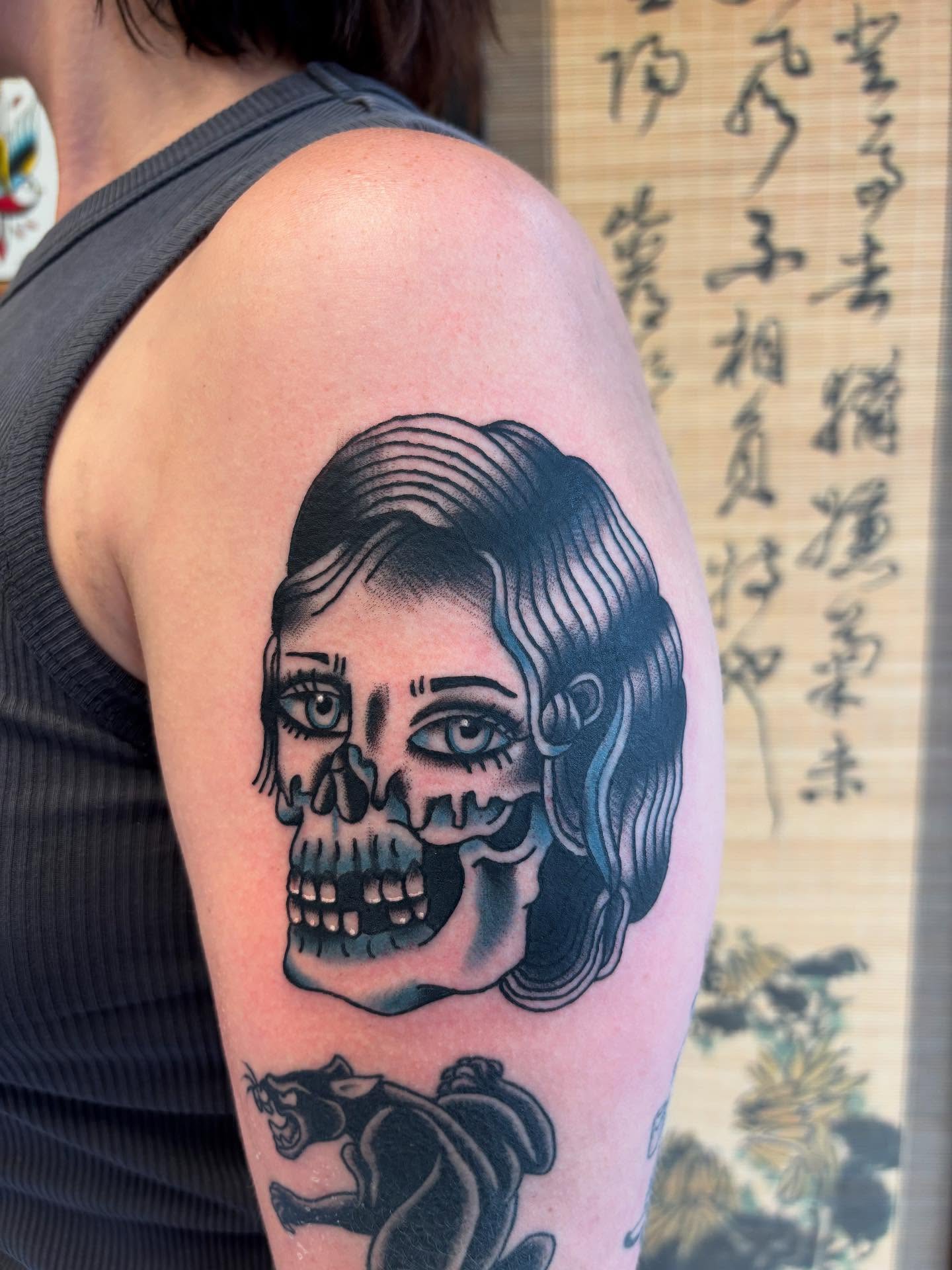 Skull with woman's face American traditional tattoo on the shoulder by Ben Whyte