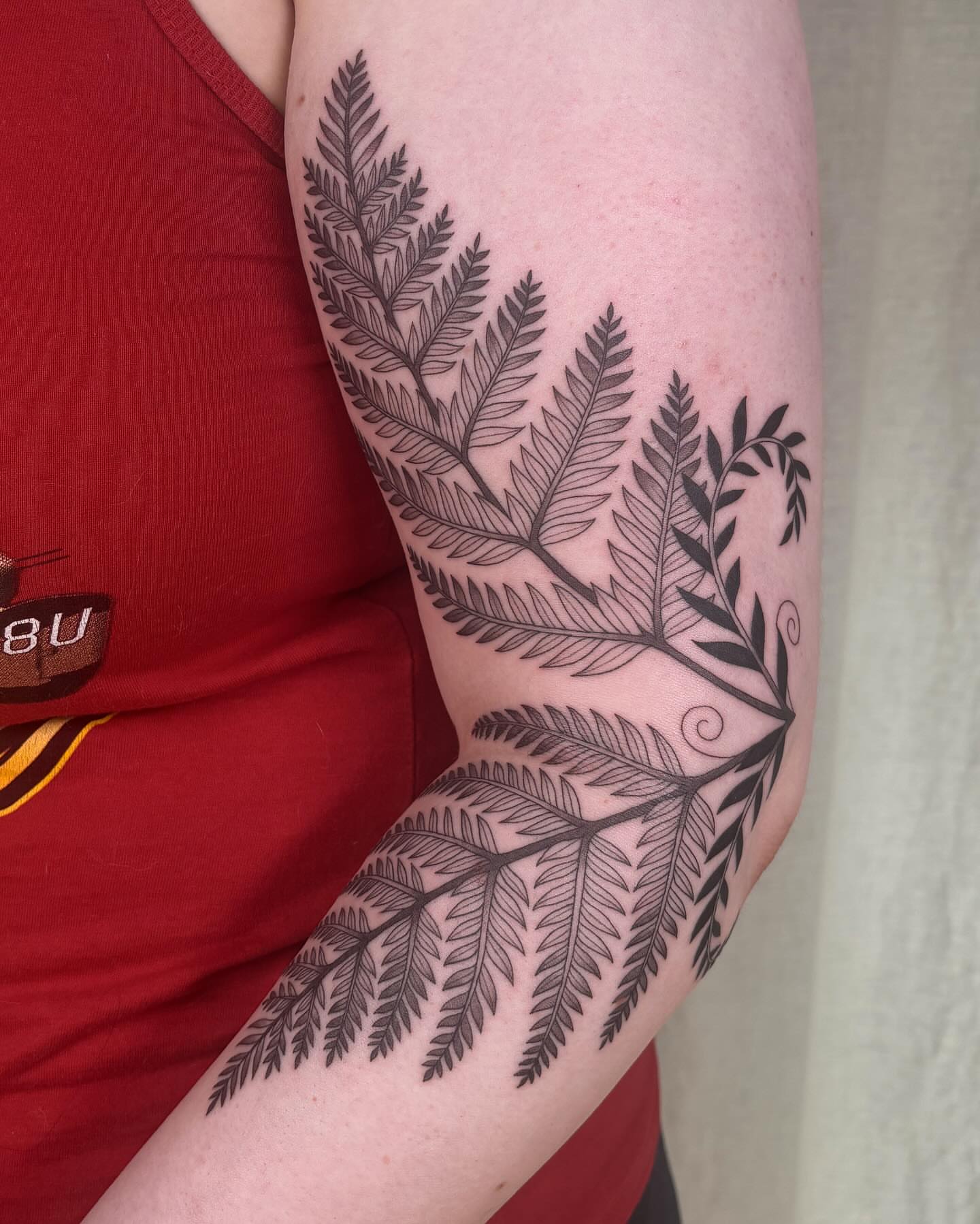 Fern black and grey tattoo on the forearm by Anna Sage
