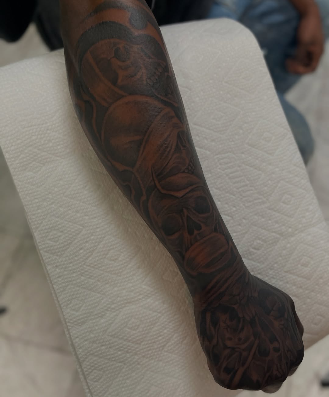 Skulls realism tattoo on the forearm by Jayme