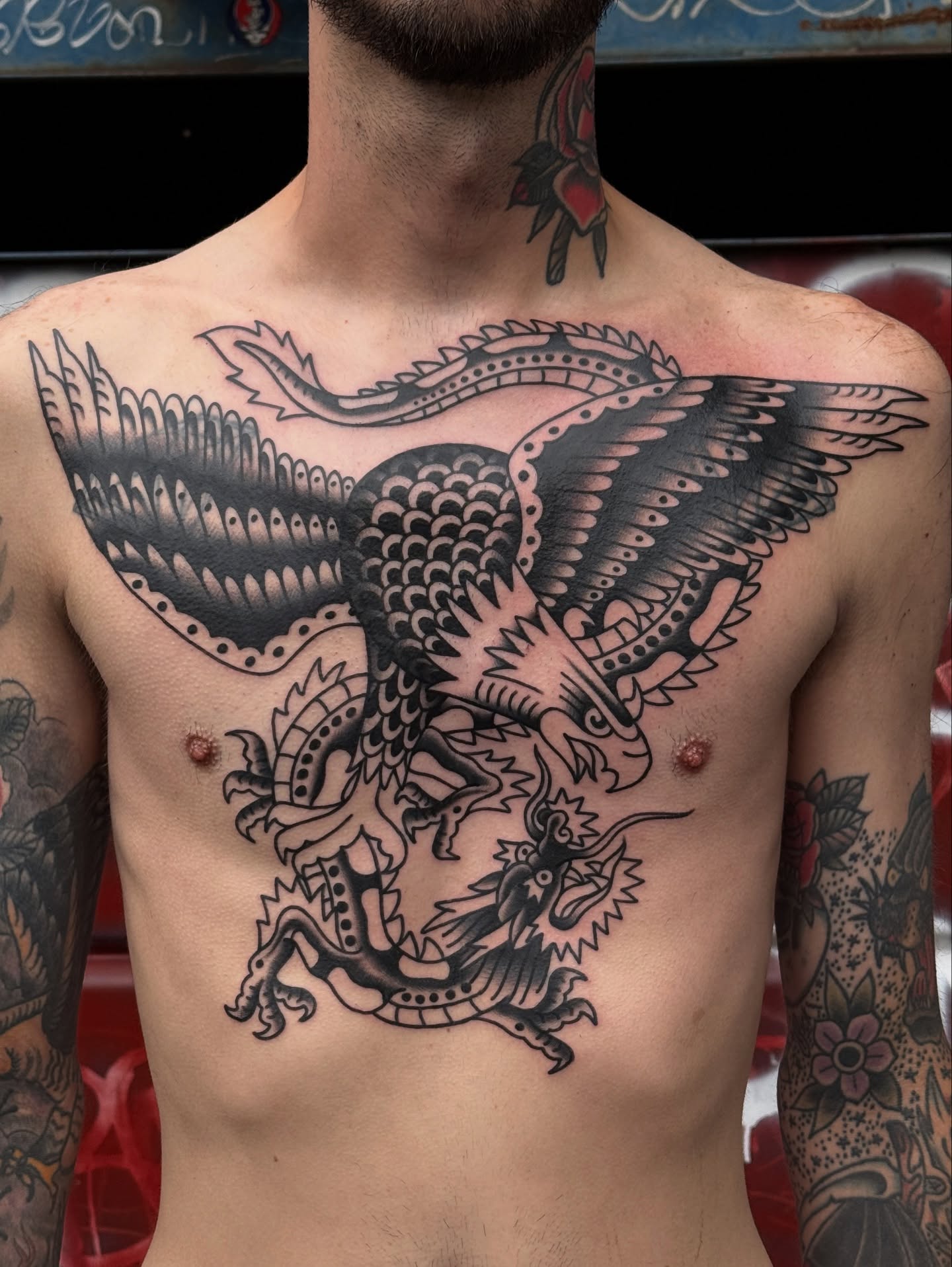 Dragon and eagle American traditional tattoo on the chest by Jordan Allen