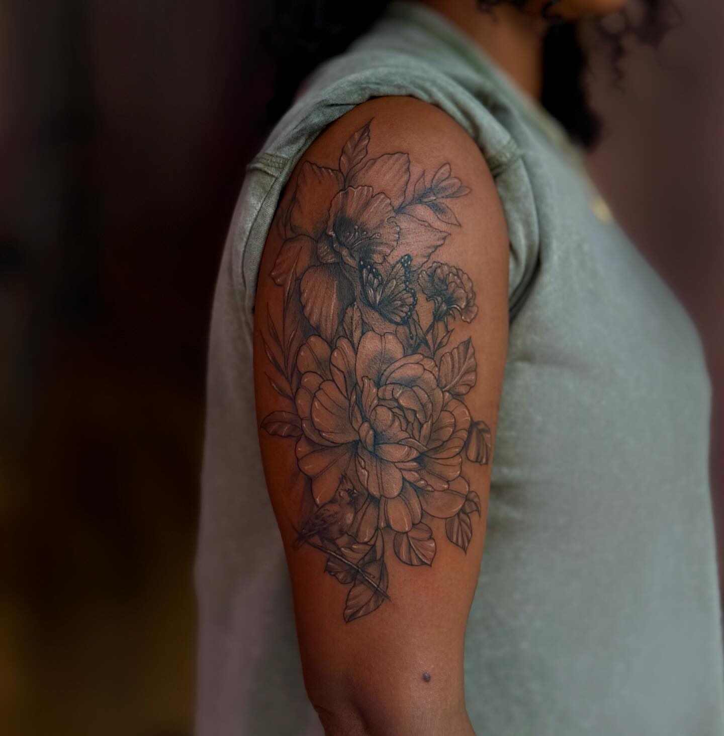 Floral bouquet realism tattoo on the upper arm by Asia Rene Tattoos👑