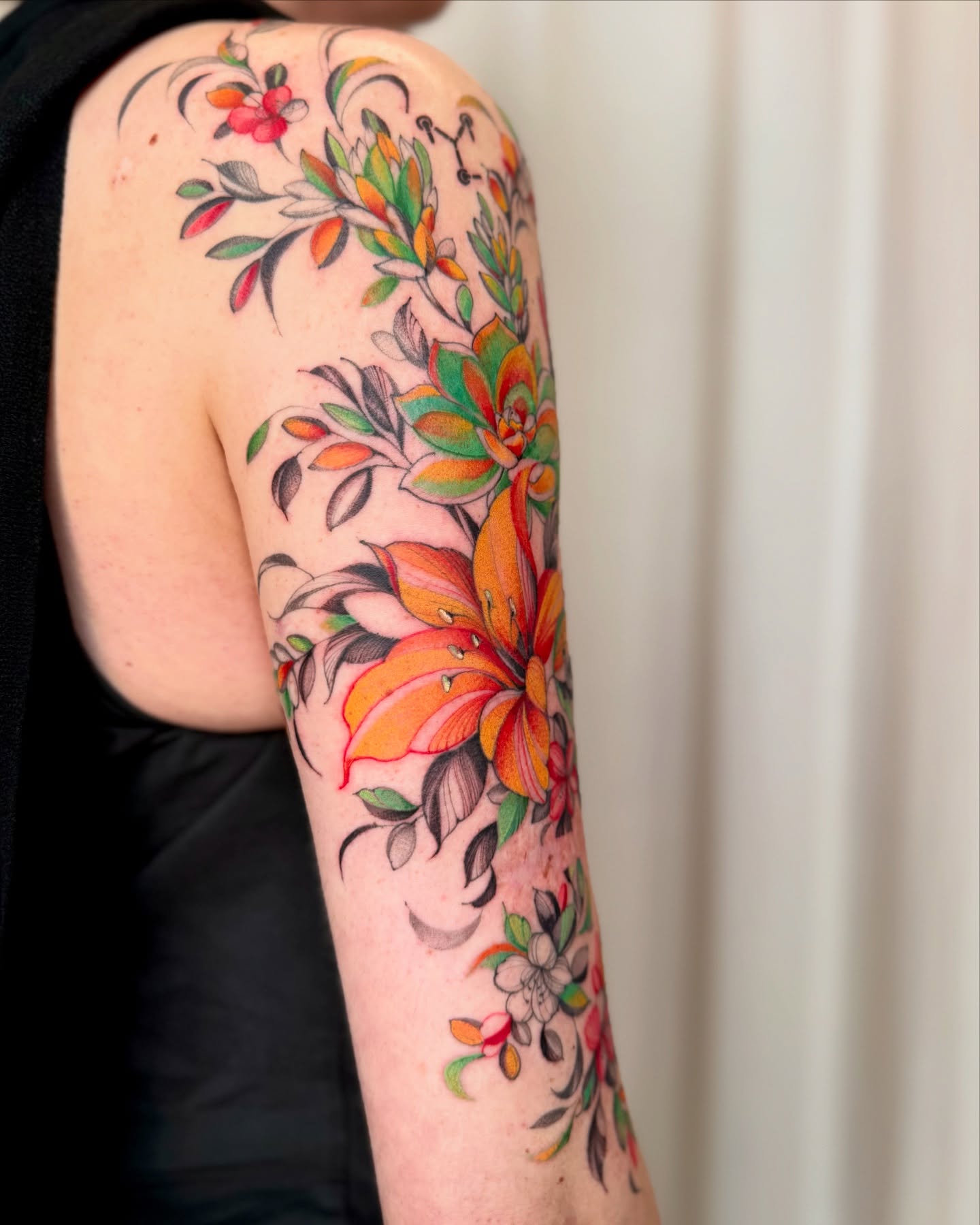 Floral arrangement new school tattoo on the upper arm by Dung Ngo
