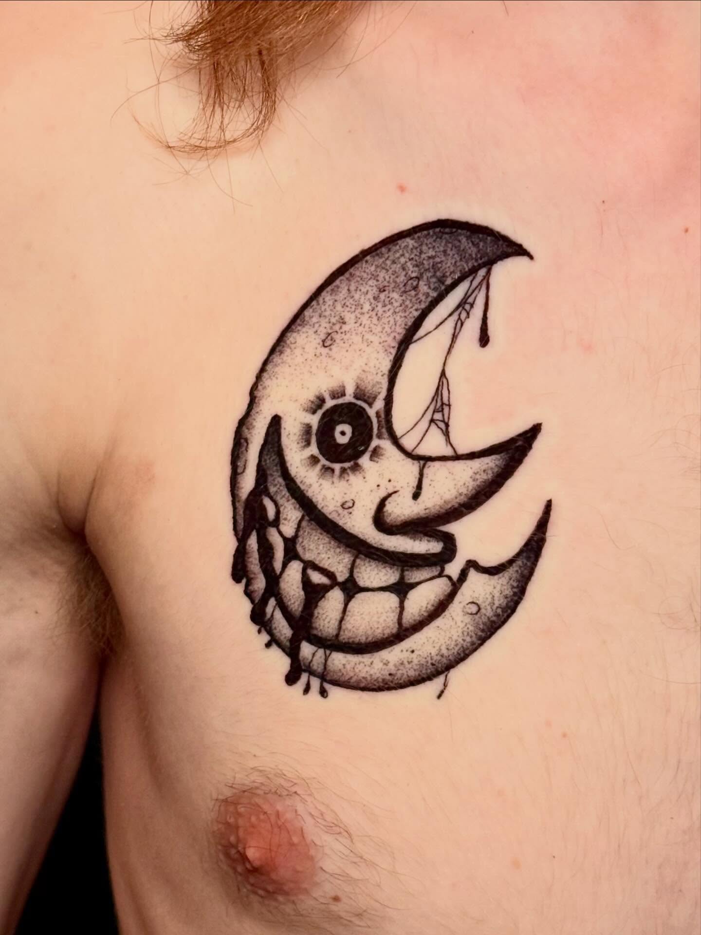 Moon with face dotwork tattoo on the chest by Jeremy Carson