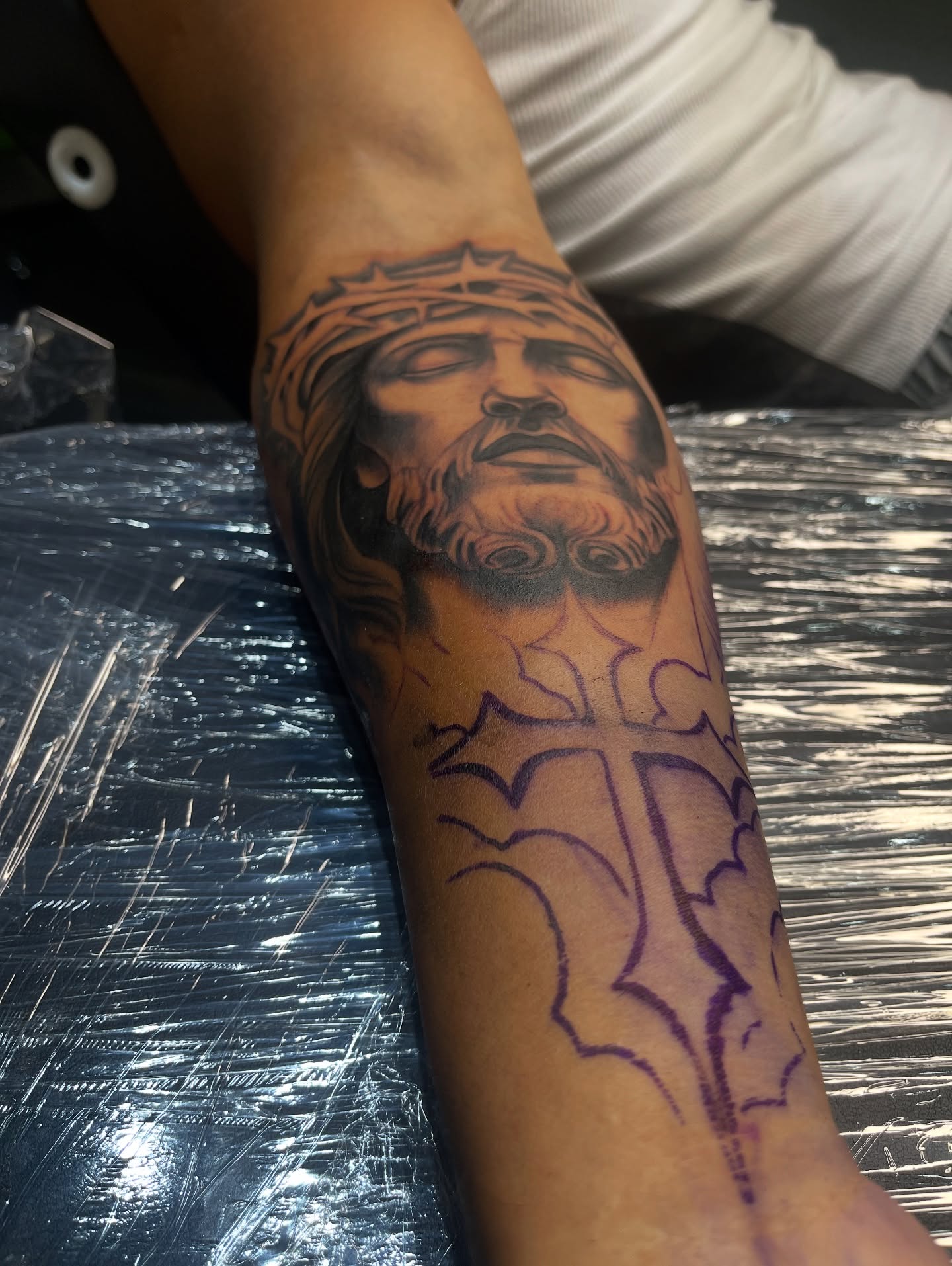 Religious figure black and grey tattoo on the forearm by Lucky Lefty