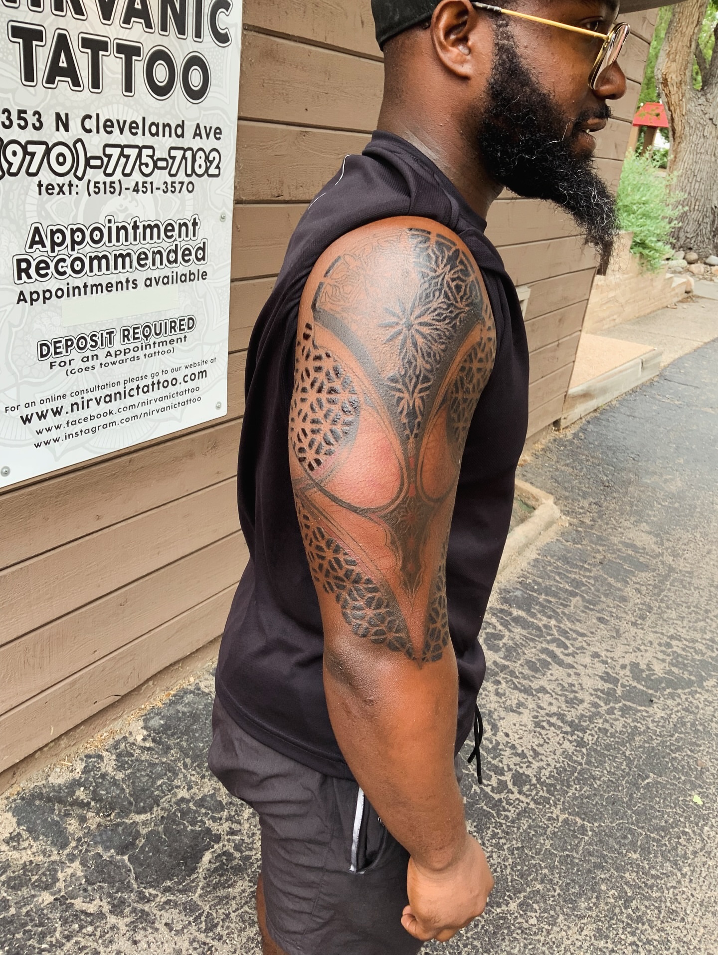 Abstract floral design geometric tattoo on the upper arm by QUEEN TATTOO Stephanie Larson