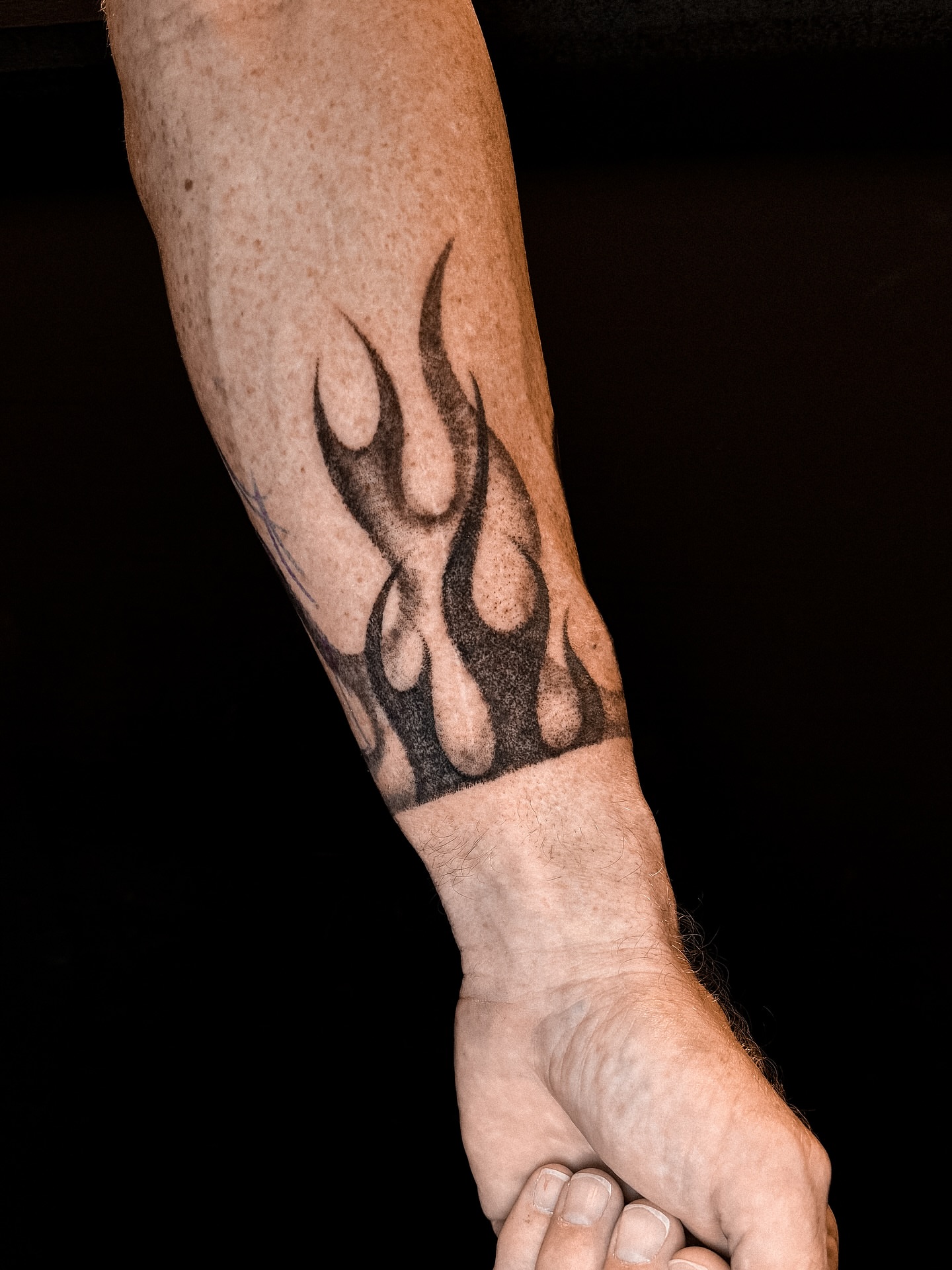 Flame tribal tattoo on the forearm by Brandt Norcross