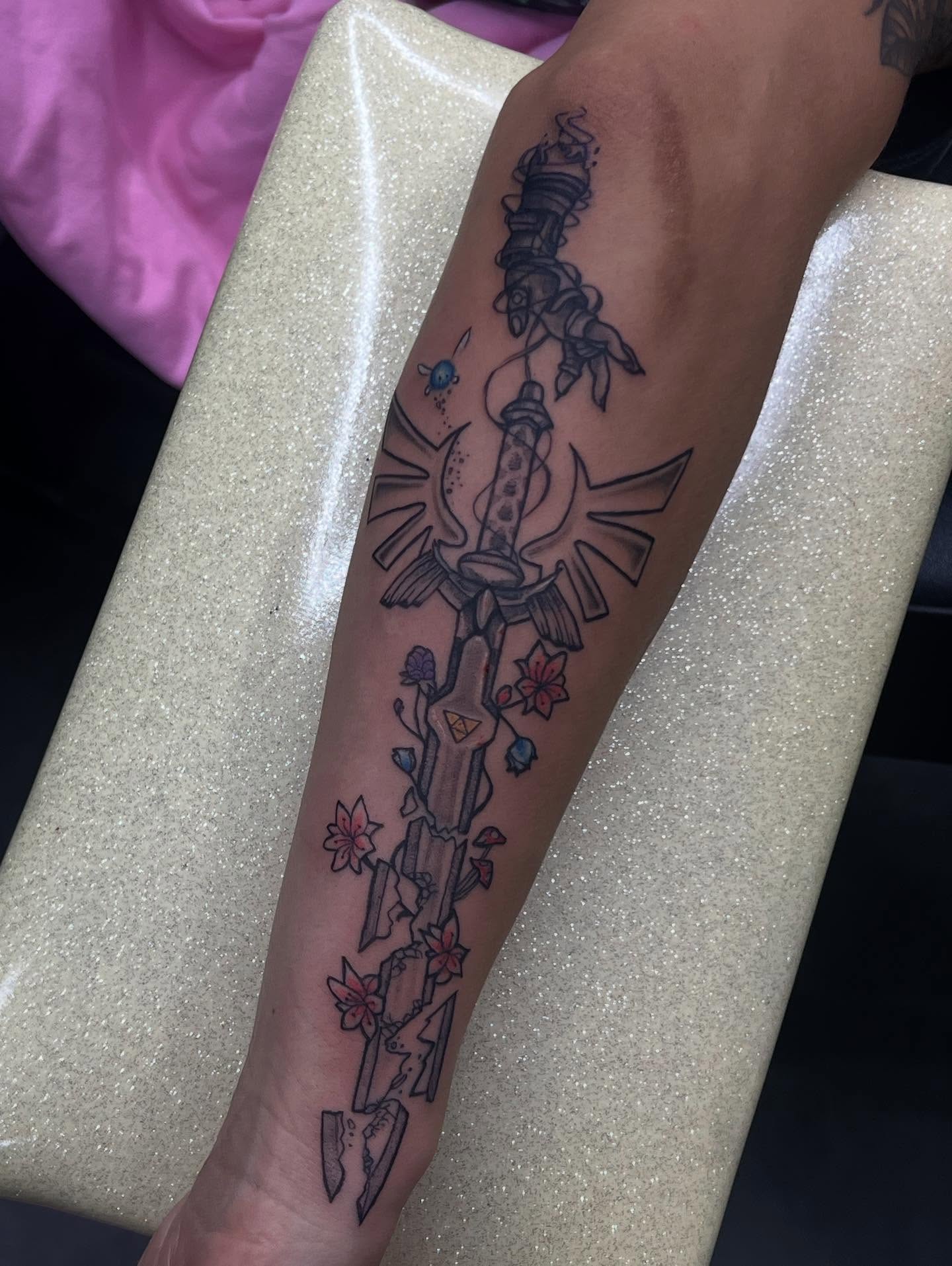 Sword and flowers black and grey tattoo on the forearm by Sav
