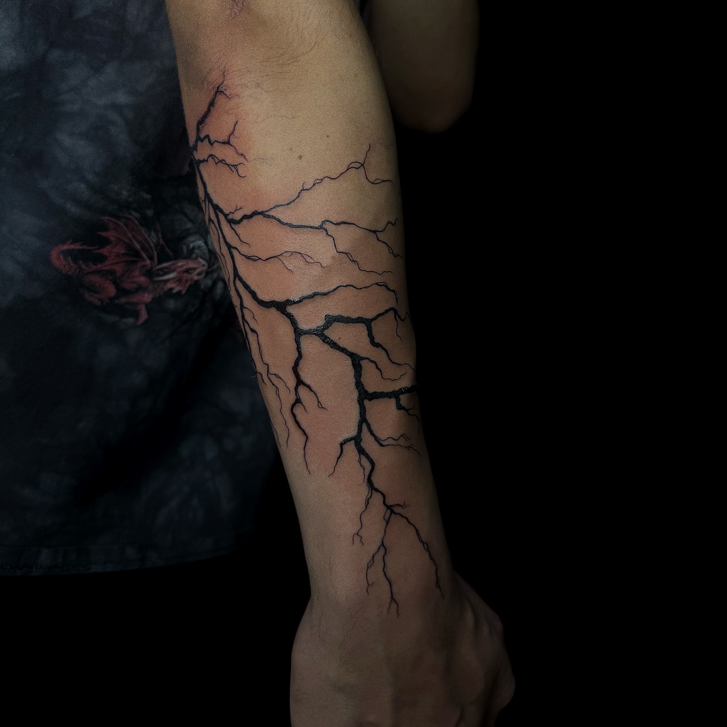 Lightning bolt black and grey tattoo on the forearm by elena