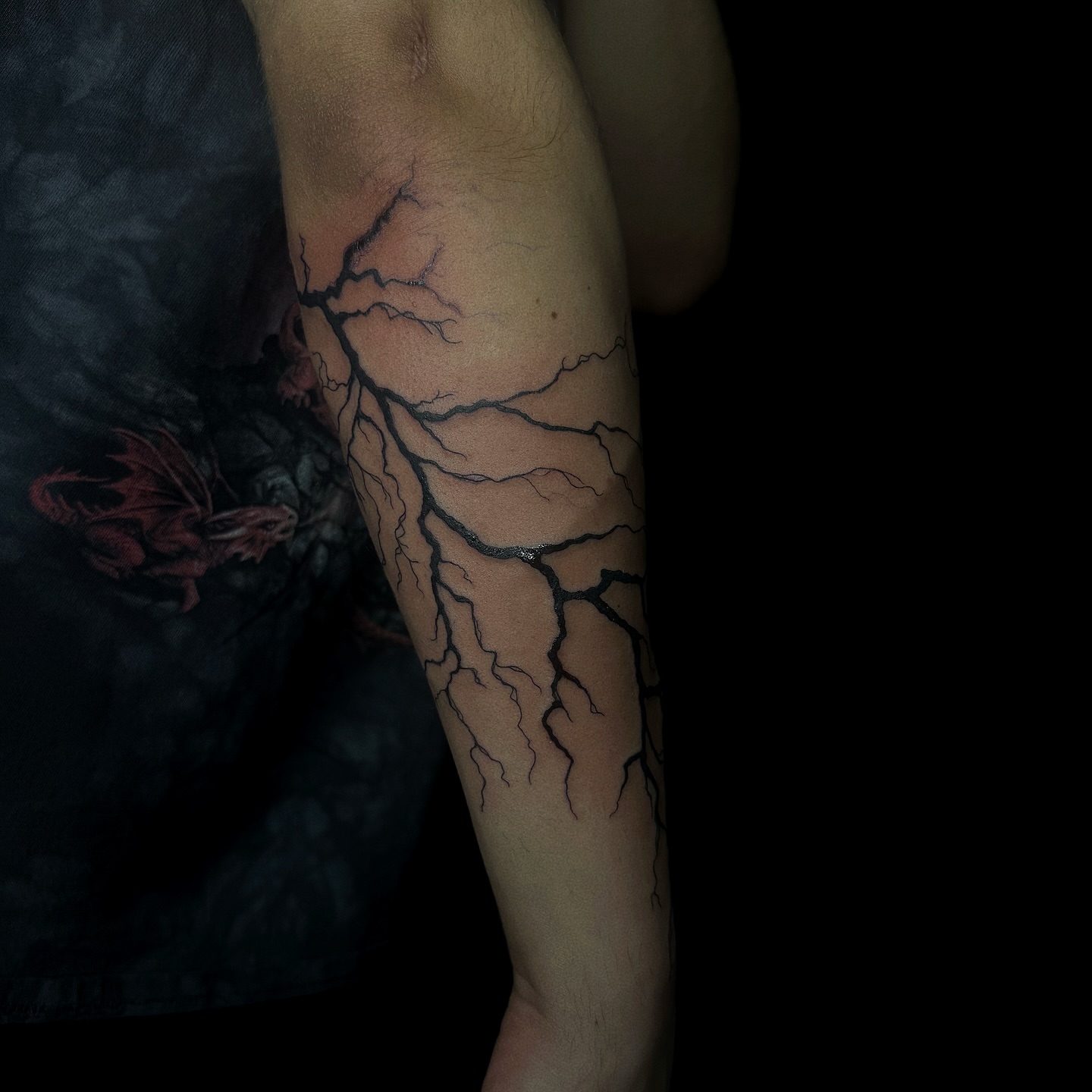 Lightning black and grey tattoo on the forearm by elena