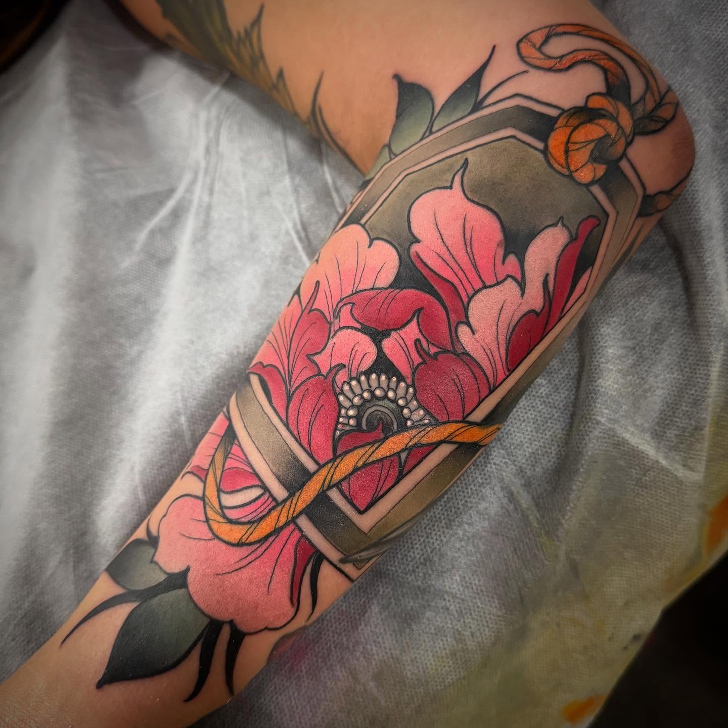 Floral bouquet American traditional tattoo on the forearm by Jason Lawyer