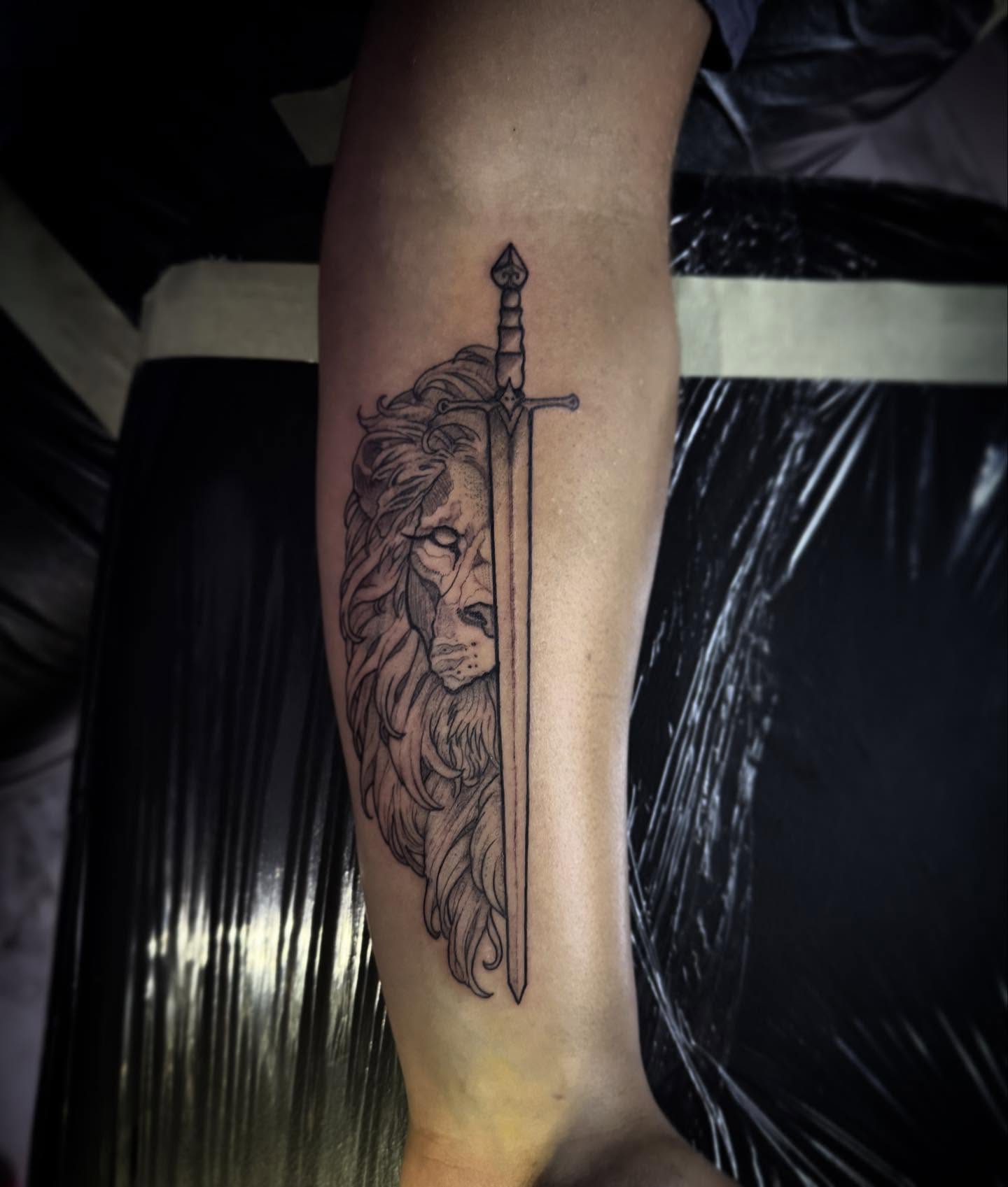 Lion and sword realism tattoo on the forearm by AaronAdlerTattoos.com, Cincinnati